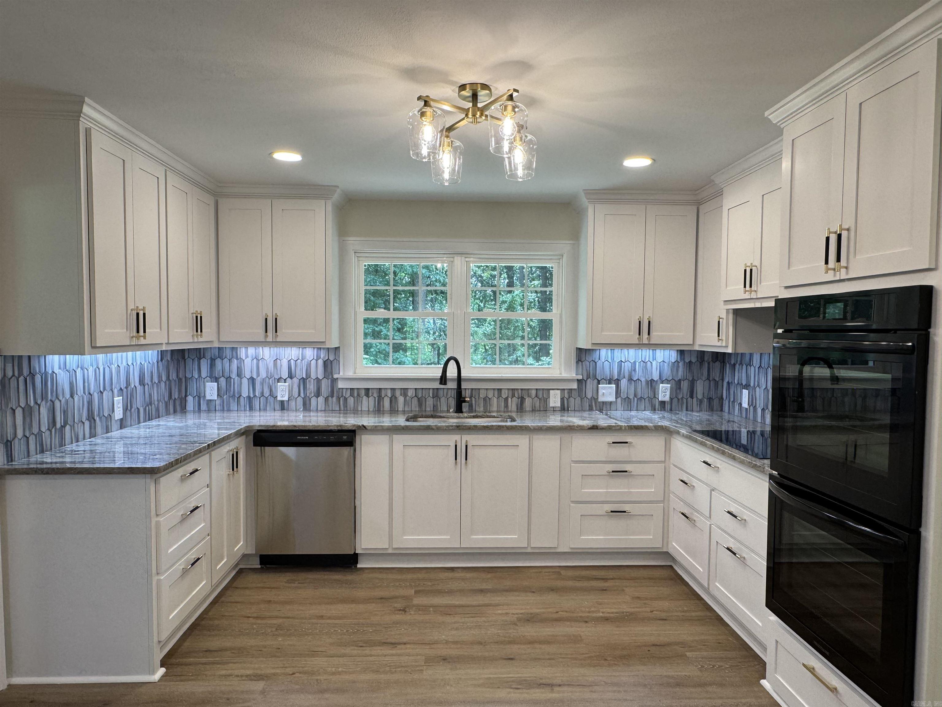 custom cabinets, double ovens, electric cooktop.