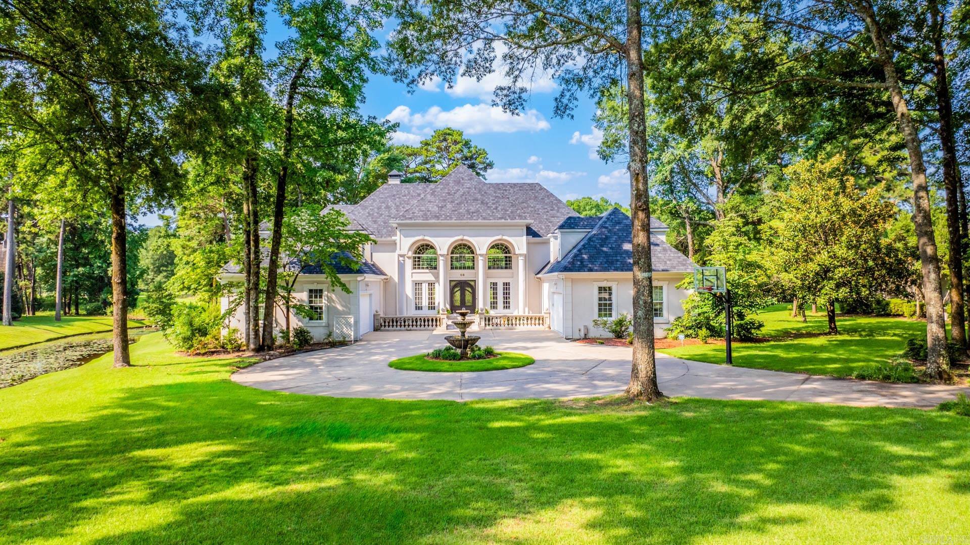 Architecturally designed home backing to Founders Golf Course is sited on 1.17 acres in The Chenal County club. The main floor features a foyer, living room, dinning area, den, kitchen, office, master suite, guest suite, and stunning sunroom. Kitchen totally remodeled with custom cabinets, and granite counters.  Upstairs has four bedrooms with three full bath, game room, and additional French veranda.  Every room is oversized/perfect, and every window looking out onto the water and golf course. Additional features include extra kitchen, 4 car garage, fountain, and circular driveway. Precious builder ( Randy Ferguson)’s home – French Villa Style Living featured in " Life in Chenal"!