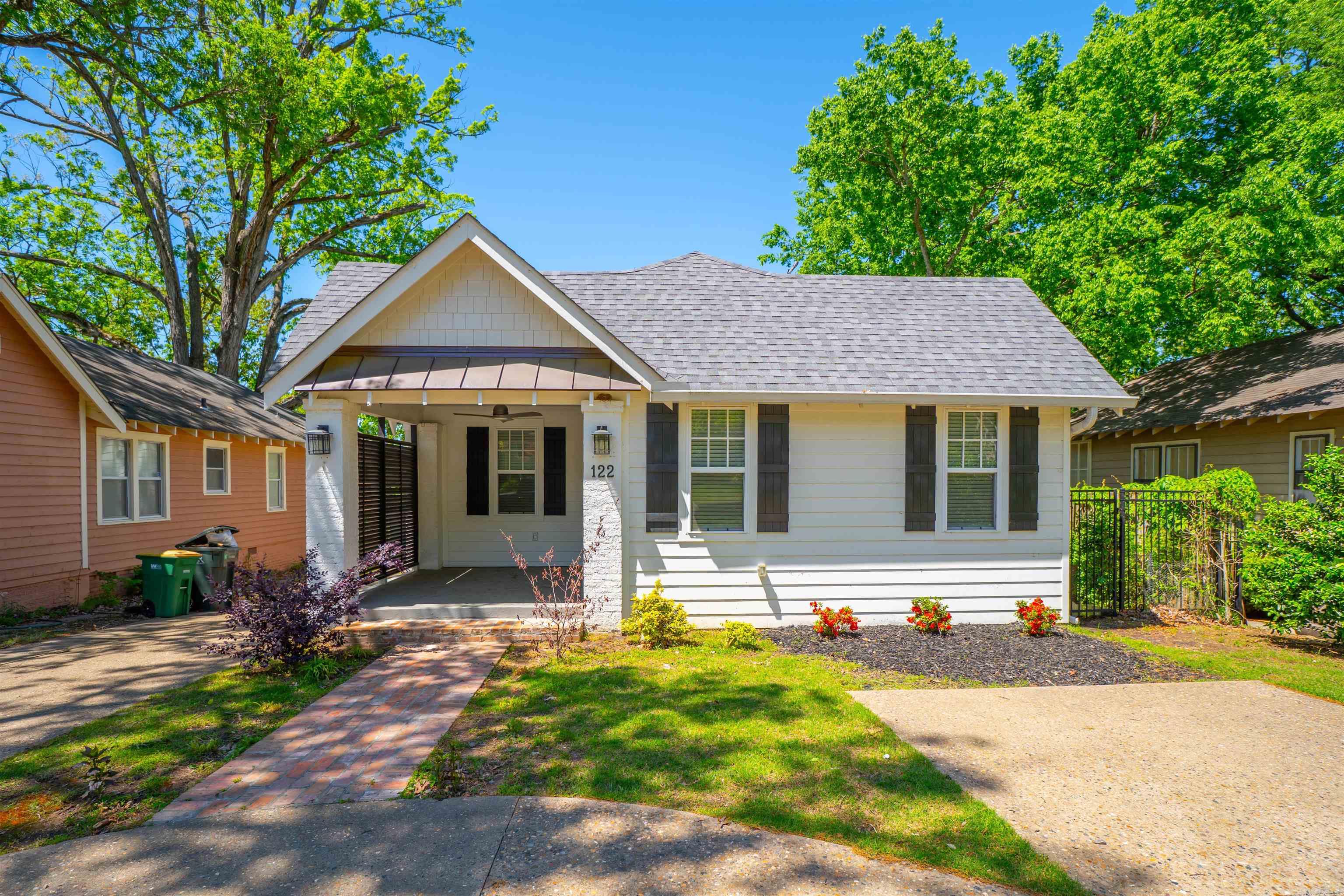 Welcome to 122 N Monroe St in Little Rock— where historic charm meets modern living! You have to see this house to believe the incredible remodel that has taken place.  The house opens into a formal living room that flows into a dining area with a wet bar, wine fridge, and built in shelving.   The luxurious primary suite is downstairs and offers a huge walk-in closet, spa bath with a soaker tub, large walk-in shower, double sinks, and water closet. A stylish half bath with quartz countertops, plus a convenient downstairs laundry, add function and style.  The open-concept kitchen features stainless steel appliances, a five-burner gas stove, and an oversized deep sink, opening to a cozy family room with a built-in electric fireplace and eat-in nook. Step through double doors to a giant covered back deck, that leads to the fully fenced backyard and also includes extra acreage beyond the fence—perfect for pets, play, or future plans.  Upstairs you'll find three generously sized bedrooms, a full bath, and attic access.   Come tour this incredible Hillcrest find today!