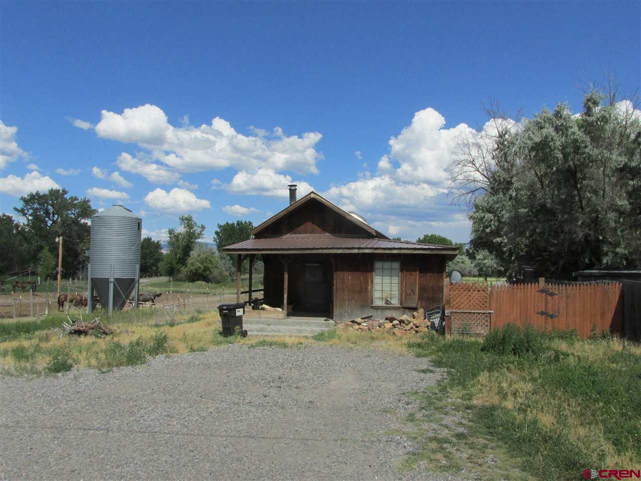 Superior Investment Property! 16.81 acres (MOL) zoned B-4 and R-3 within the City of Montrose and next to the new Colorado Outdoors 164-acre multi-use river development. Sizeable acreage for commercial and/or residential development. Property has 696 sq.ft. 1bd/1ba home, pasture, ponds and horse stalls that are currently leased. Property also has irrigation rights. Beautiful acreage and nature views. The possibilities are endless with this land! There is an estimated 2021 split fee of $500 for UVWUA for this property.