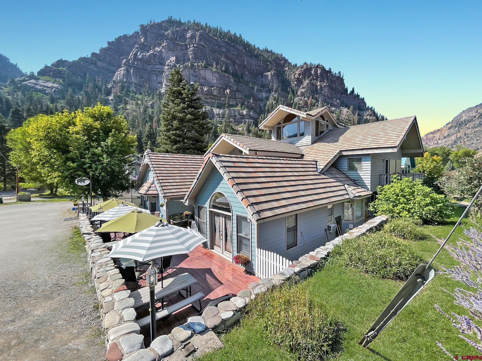 11% CAP rate in 2021!   Live/Work/Invest in beautiful Ouray.   9 diverse guest rooms spread across two floors with private bathrooms and direct access to the outside plus spacious common areas and onsite owner/manager quarters.   Almost 5000 livable square feet on a large lot with wrap around decks and a big basement. A premium quiet location just 200 feet from the Uncompahgre River 2 blocks from Main Street in downtown Ouray.   Purpose built as a Bed & Breakfast (not a retro fitted house), the Black Bear Manor is recording record occupancy & revenue numbers in 2021. Business & real property now offered turn-key ready and fully furnished with everything necessary for a smooth take over.   Offered at only $319 PER FINISHED SQUARE FOOT - a tremendous value for an asset of this size and location.  The Black Bear Manor B&B has a solid history of stellar reviews, including a 5 Star Rating and a Certificate of Excellence from TripAdvisor. Repeat guests are common and updated books supports asking price with a strong CAP.   Center of town location on 6th Avenue makes for an easy walk to downtown shopping and restaurant district, as well as the new Ouray Via Ferrata and the world-famous Ouray Ice Park.   This property features:  • 1696 sq. ft. wrap-around deck with picnic tables, a porch swing, umbrellas, café-style outdoor seating, and a 24-hour guest hot tub.  • 3rd Floor Observatory/game room provides a panoramic view of the surrounding cliffs and mountain peaks, including the Amphitheater, Mt. Hayden, US Mountain and Mt. Abrams, just to name a few.  • On-site and off-site parking. • 100-year multicolored, concrete tile roof. • Nine fully furnished, uniquely decorated guest rooms, some with fireplaces and whirlpool tubs.  • Owner/Manager quarters could be converted into a 10th guest room if so desired. • All rooms feature their own private bathroom and external entrance for convenience and easy ingress/egress. • Owner/Manager quarters could be converted into a 10th guest room if so desired • Large laundry Room with Commercial Dryer • Large basement for storage, a workshop, or future expansion. • Kitchen features a gas Viking stove, complete with dual ovens and a griddle, making this a baker’s dream. Large freezer, baker’s rack, commercial refrigerator, and pantry with additional storage. • Many upgrades, including new flooring, window coverings, updated boiler and plumbing, just to name a few.  This business is a TURN KEY OPERATION, with the opportunity to generate increased revenue through multiple avenues.   At full asking price of $1,595,000 the Black Bear Manor is being offered at only $319 per finished square foot - a TREMENDOUS VALUE for a large asset in a central downtown location.  Click on the Matterport 3-D virtual walk-through in the link below to see all guest rooms and common areas.  Nothing beats seeing it in person...contact Broker to arrange your personal tour and see the beauty of Ouray for yourself.  You won't regret it!