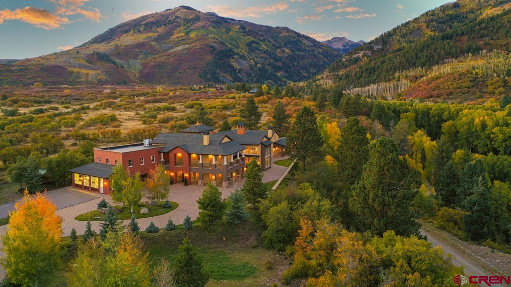 "OPULENCE IN THE MOUNTAINS!" Describes this 175-acre estate that borders three sides of 1.85 million acres of the San Juan National Forest. The property is split by the La Plata River that is serviced by a magnificent bridge that connects the property. Combining the 175 acres property with the bordering National Forest makes the estate feel much larger than its deeded acreage--that includes five Colorado mountain peaks. THE INTERIOR is designed for comfort with World Class Finishes and Quality Workmanship in every aspect of this Custom Built Mountain Modern, Four Story, 18,000 square foot Main House with opulent furnishings and Three Floor Elevator that is finished in Pecan Wood. There are multiple attached patios and balconies encompassing the perimeter of the house. The area off of the Great Room and Master En-Suite has a Fireplace with covered seating.  THE MAIN/SECOND FLOOR features: There is an open concept three room area - first a massive Great Room with a castle designed Fireplace and 22ft Aspen Wood Ceilings that is the focal point of the majestic mountains with views through panoramic floor to ceiling windows. Next a Formal Dining Room to host family holiday meals and stately dinners that opens to a dine-in Chef's Kitchen with Butler's Pantry with unlimited storage. All with Granite Countertops, Custom Cabinets, Kitchen area with Viking Oven, Gas Range, Oven Warmers and Sub-Zero refrigerated drawers. The two-story Master En-Suite includes a Fireplace, Walk-In Custom dual Closets, Master Bath, Foyer and a Second Story Bonus Room with magnificent views. Adjacent to the Master Bedroom is a Fitness Center that includes a Lap Resistant Pool and Private Bath. Just off the Entrance there is an Execute Office with fire-proof filing cabinets. Across from the Office is a cozy Library with Fireplace and floor to ceiling Pecan Book Shelves that is a perfect venue for relaxing with a book or for Executive Meetings. There is a Three Car Heated Garage with an attached 800 square foot Greenhouse, Mud-Room Entry to the house with lockers and a half bath.The Driveway is constructed with heated pave stones.  THE BOTTOM/FIRST FLOOR features: A comfortable, professionally decorated area that feels like a luxurious Antique Opera House with 12 seat Home Theater that is powered by Apple TV, separate Snack Bar with sink and refrigerator entrance area. Also sound proof Music Production Room. This floor includes a Half Bath and large Storage Room on this level.  THE UPPER LEVEL/THIRD and FOURTH FLOORS features: A huge Game Room with a Wet Bar, Three Guest Bedrooms (one used as Children/Teen Bunk Room area) with their own private Bathrooms. You climb the open stairwell to the top/fourth floor Zen Room that has the most beautiful views of the Estate and surrounding Mountains!  SEPARATE STRUCTURES INCLUDE:   *CARETAKER HOUSE: This is a 2550 square foot, Three Bedroom, Two Bath, Two Car Garage. *FOUR STALL BARN: This is a 4356 square foot Barn with Washing Basin. *POLE BARN WITH A UTILITY ROOM AND COVERED OUTDOOR HORSE ROUND PEN: This is a 3650 square foot area.  *OUTDOOR PAVILION: This area includes a full service Kitchen with an Imperial Range Oven with Stove Top, a Serving Area with a Fire Pit in the center of the Pavilion. Also, His and Her Four Stall Restroom/Bath House with a Two Car Garage and RV Pad with Hookups.  *SPECIAL NOTE: This Property includes one of the largest Solar Panel Projects for Utilities in the history of Colorado for SF residence with utility bills averaging $66.00 a month! Power is backed up by an 85 Kilowatt Propane Generator. There is room for expansion with utility hookups to create more potential trophy home sites. This Property is located in an incredible setting for a multitude of activities – camping, fishing, hunting, horseback riding, hiking, ranching, snowmobiling, snowshoeing, cross country skiing, entertaining or just relaxing.  Only 15 Minutes to shopping, dining and nightlife. 30 minutes to Jet Serv