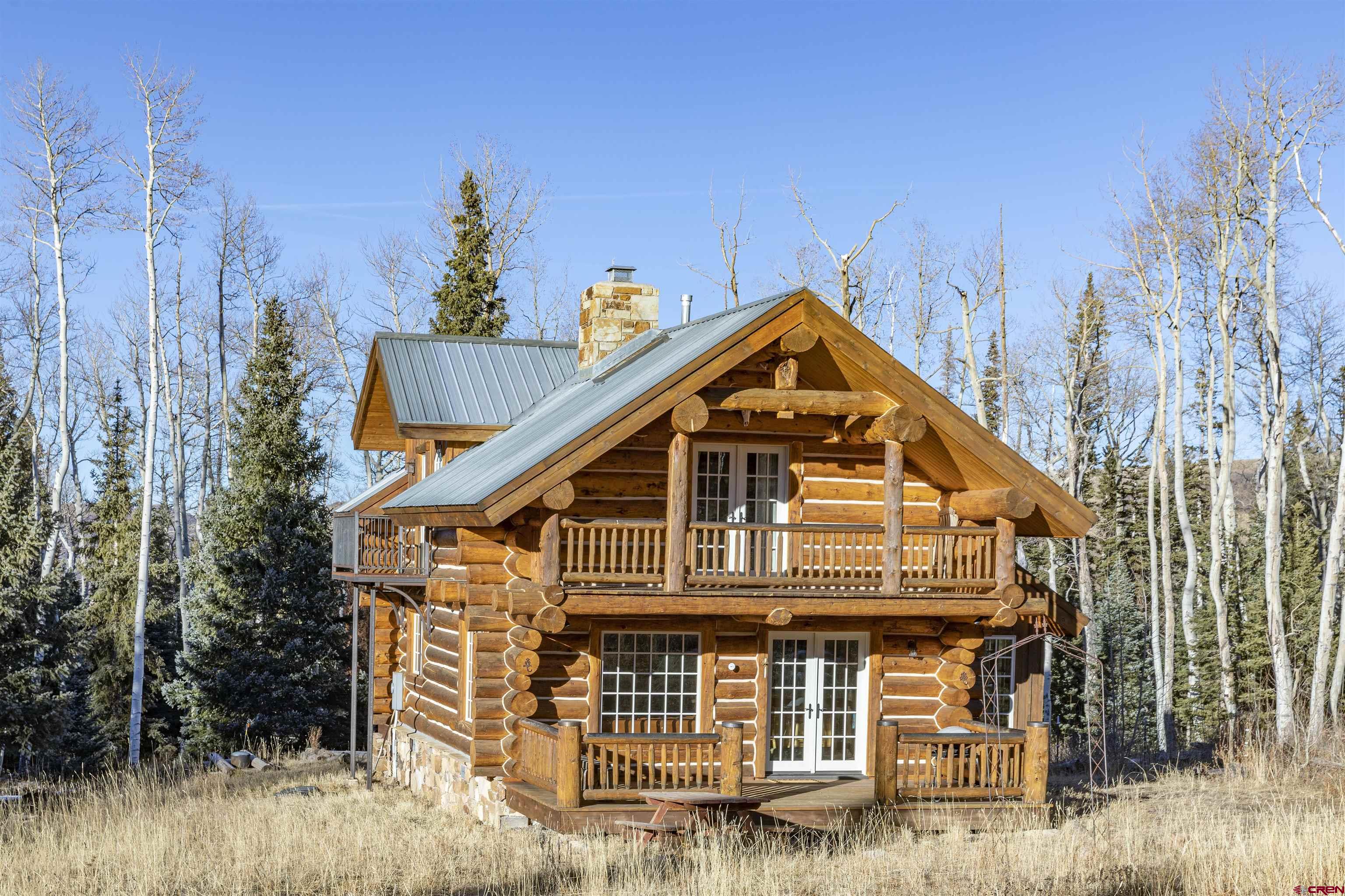 Spectacular Mountain Chalet, affectionately known as ''Flying Elk'', located on Hastings Mesa at the base of the Sneffels mountains in San Juan Vista on 7 very private acres surrounded by aspens. A Ted Moews custom designed and built log home for this original owner is made of hand hewn logs and has all the amenities: dishwasher, washer/dryer, microwave, refrigerator, gas range, custom oak cabinets, silestone quartz kitchen counters, in floor hydronic heating, and a Hughes Net satellite system. Solid hickory floors, a Rumford fireplace and custom true divided light French doors and windows with custom log window buck frames that are truly special. 3 large decks framed with copper rails and one iron Truman balcony off the second story guest bedroom.  This property has maximum southern exposure and views of western sunsets. The East property line of this home borders the Double RL ranch so the privacy is incredible. To the South you have direct access to the adjoining Sneffels Wilderness area and the San Juan National Forest. This is the perfect mountain retreat for Hunting, Hiking, Ski Mountaineering (Hayden and North Pole Peaks are essentially in the backyard!) mountain biking (San Juan Hut system Hut is a mile away) mushrooming, nordic skiing etc. About any mountain activity you can think of is out the door."
