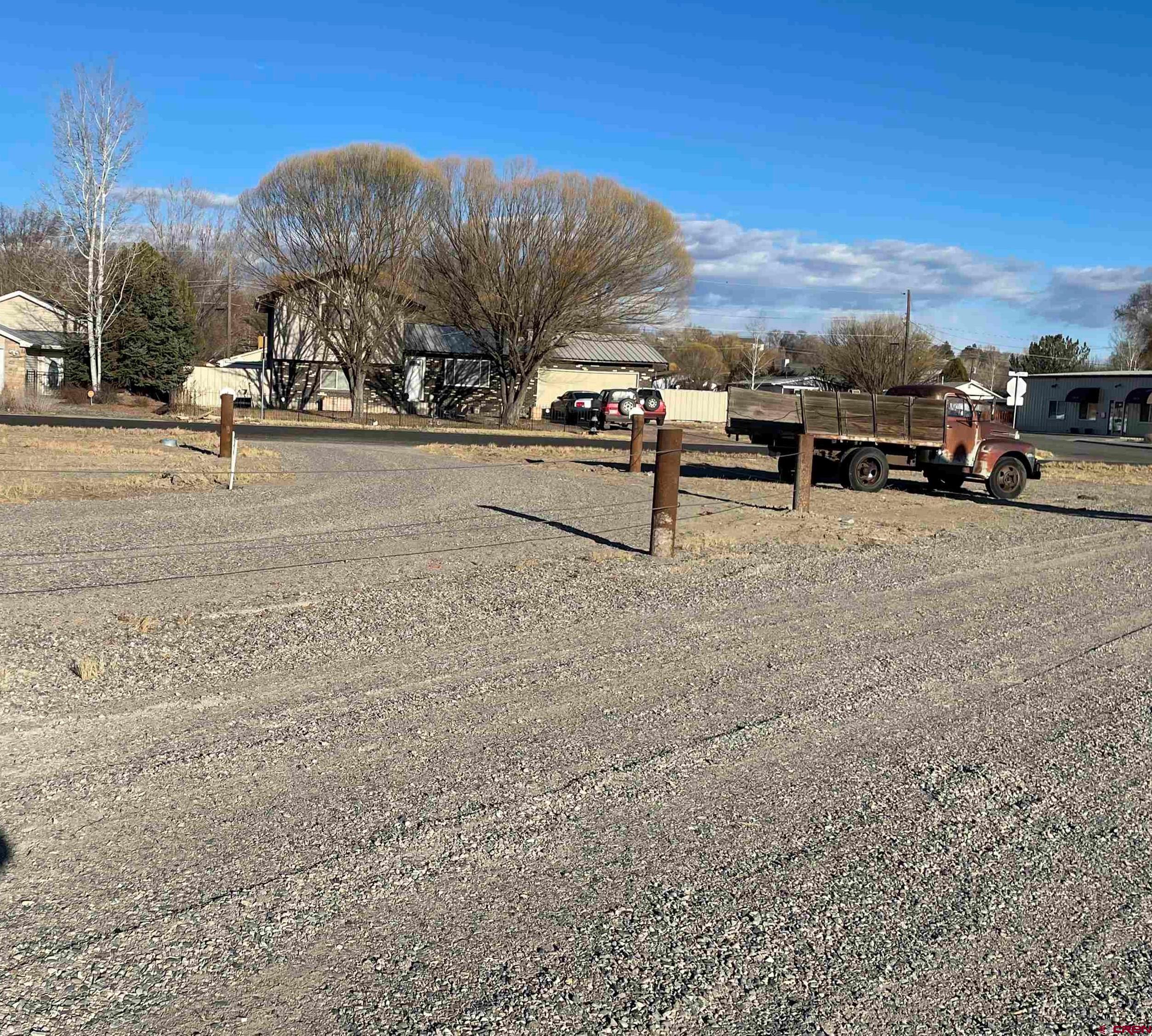 This lot is in an excellent location in downtown Delta on the corner of Hwy 50 and Grand avenue.  Easy access on and off Hwy 50.  New 200 amp electric service, New rusty metal privacy fence.  Three water taps from City of Delta and 2 City of Delta sewer taps.  Natural gas to lot line.  New Graveled parking lot and circle drive.  230 feet of Hwy 50 frontage and 250 ft of Grand Ave frontage, two entrances already established off grand one one off Hwy 50.