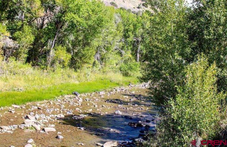 Paonia Acreage on the River!  Do you like to FISH?  Here is a rare chance to own 10.9 acres of RIVERFRONT land just 2 miles from downtown Paonia.  This property provides over 400 feet of shoreline on the North Fork of the Gunnison for your fishing pleasure; even better, the property extends over the river so both banks would be yours.  The bulk of the land on the south side of the river has supplemented soil that has been used for organic agriculture so growing things here will be easy, especially with 10 shares of Stewart Ditch for irrigation. (Well or cistern will be required for household water.) Think about it: this could be your dream getaway property down a peaceful back road.  On hot days, wander down to the riverbank and enjoy a cooling soak.  Or drop a hook in the water, do a little gardening, sit back and enjoy the good life!