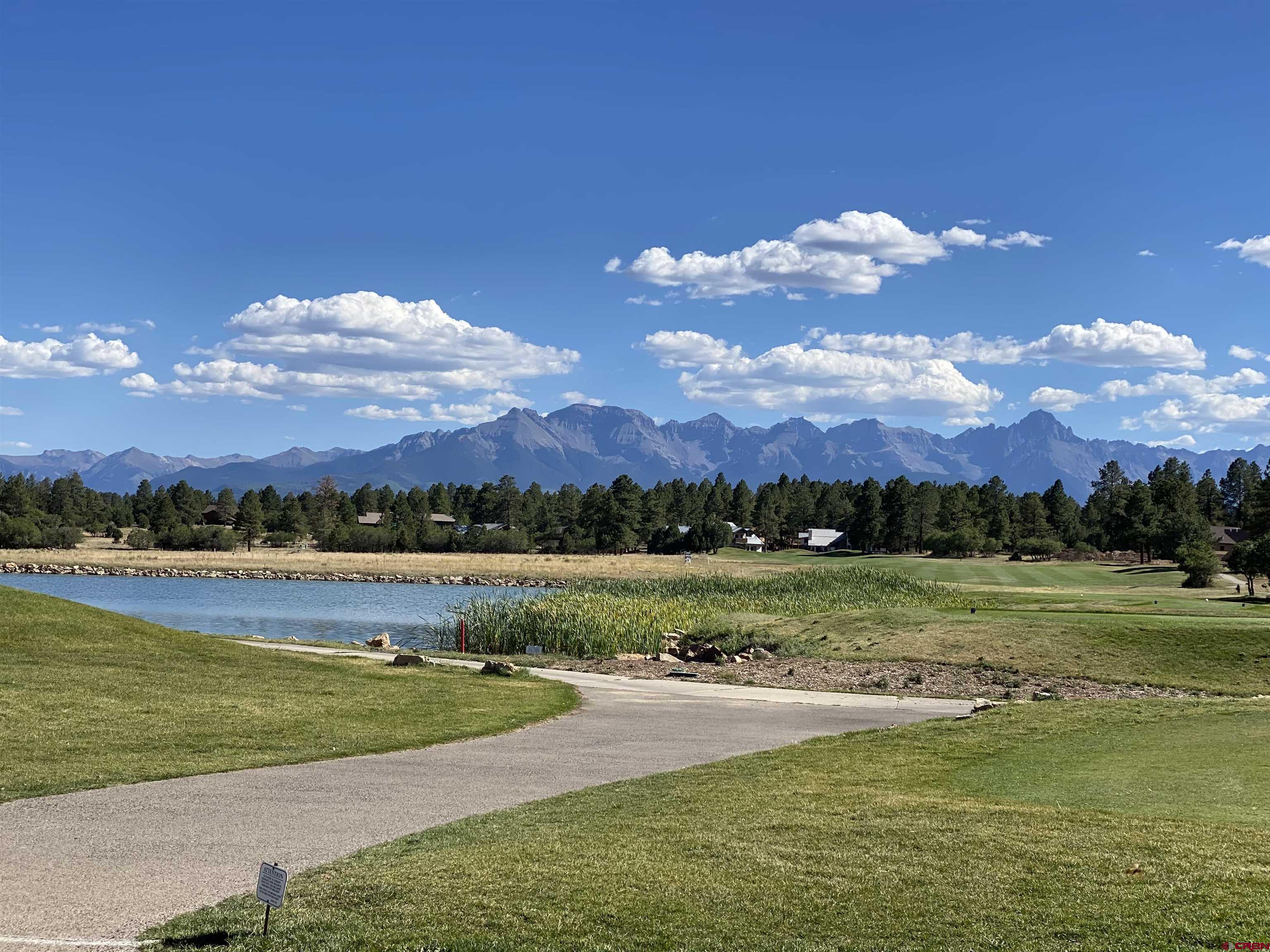 Level building site with many big Ponderosa Pines. Fronts the Divide Ranch and Club golf course 7th hole, sweeping views of the Cimarron Range.