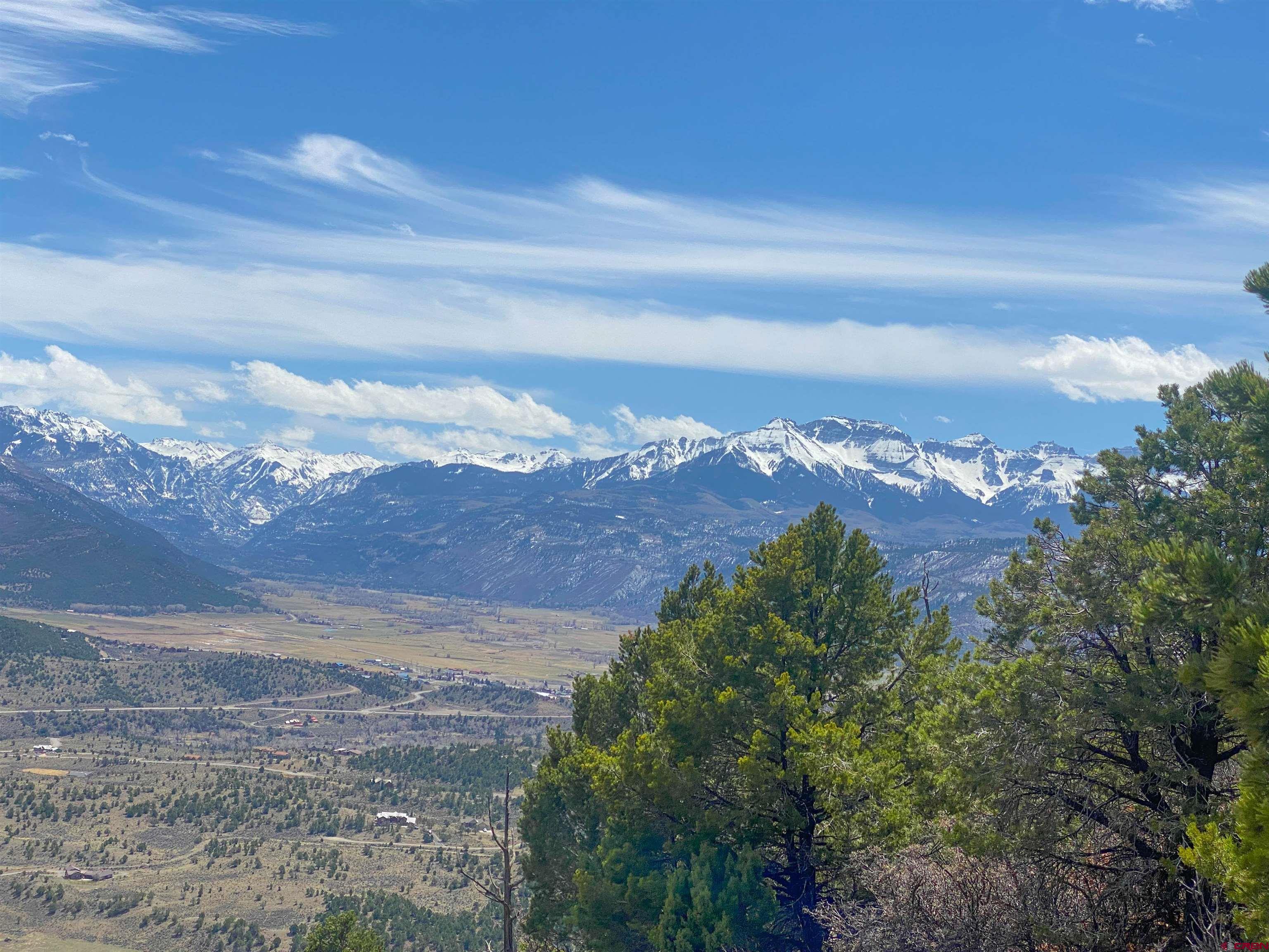 Log Hill Mesa Escarpment lot overlooking the Ridgway and Ouray Valley. With unhindered sweeping views of the Cimarron Range all the way to the Sneffels range. This nearly 3 acre parcel is ready for your dream home surrounded by Log Hill Village trail system and backing sitting on the Escarpment. The lot includes a paid Dallas Creek Water Tap, and all utilities to the lot line including Fiber Network.
