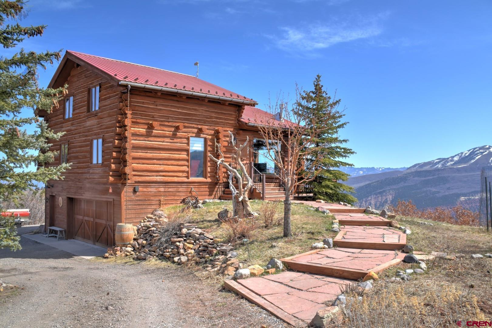 Rare opportunity Log home sitting on the escarpment. Unbeatable views of the Cimarrons, San Juan Range and Mt. Sneffles. 44 Fawn Lane features a grand great room looking directly into the Cimarrons with a Vermont Castings Propane Stove. Eat in Kitchen, along with a walk in pantry with a open concept dining room.  Ideal for both formal and informal entertaining. Just down the hall from the kitchen there is a main floor bedroom along with a full bathroom. Upstairs you will find a sleeping loft with a fully renovated bathroom featuring 360 degree views all the way to the grand mesa.  Lower level Master suite features large bathroom, private entrance and a large deck.  Large 2 Car Garage where you will find a utility sink, washer and dryer, workbench. With fine Craftsmanship, unbeatable views, 3 private sleeping quarters, high speed internet installed, exterior shed installed and included. This is the one! Ready for a full time residence or a mountain getaway, just 15 minutes from Ridgway. Seller will be taking offers until Friday the 22nd at 11:00 am.