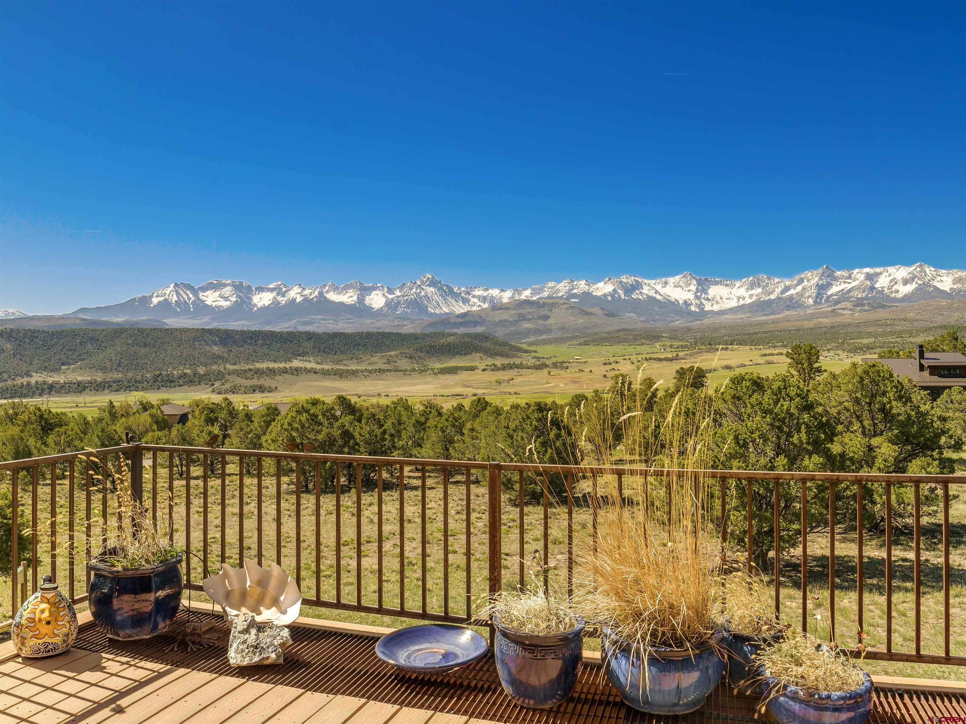 IT IS ALL ABOUT THE VIEW! Here is your dream property!  Don't miss the opportunity to own this well maintained Log Home on 3.1 acres with one of the BEST San Juan Mtn Views Ouray County has to offer!!  You will seriously fall in love with this awesome 180 degree view of the East Cimarron Range, South Sneffels Range and West to the Dallas Divide.  Quality through out with a cozy log cabin feel, 4 bedrooms, 3.5 baths, wood burning stone fireplace and a pellet stove, large low maintenance decks, hot tub included, 520sq' caretakers unit on the lower level, large game room (pool table included), lots of storage, attached two car garage.  Snow-melt system for front entry walk, parking slab, roof and gutters. Metal roof and high-efficiency boiler installed 2019.  Detached garage built in 2010 with 8800 watt solar system installed on the roof.  Garage is 523.8 sq' (33'x16')  Green house built/attached to the SW end of the detached garage.  Must see to appreciate!  Spectacular San Juan Mountain View!!!