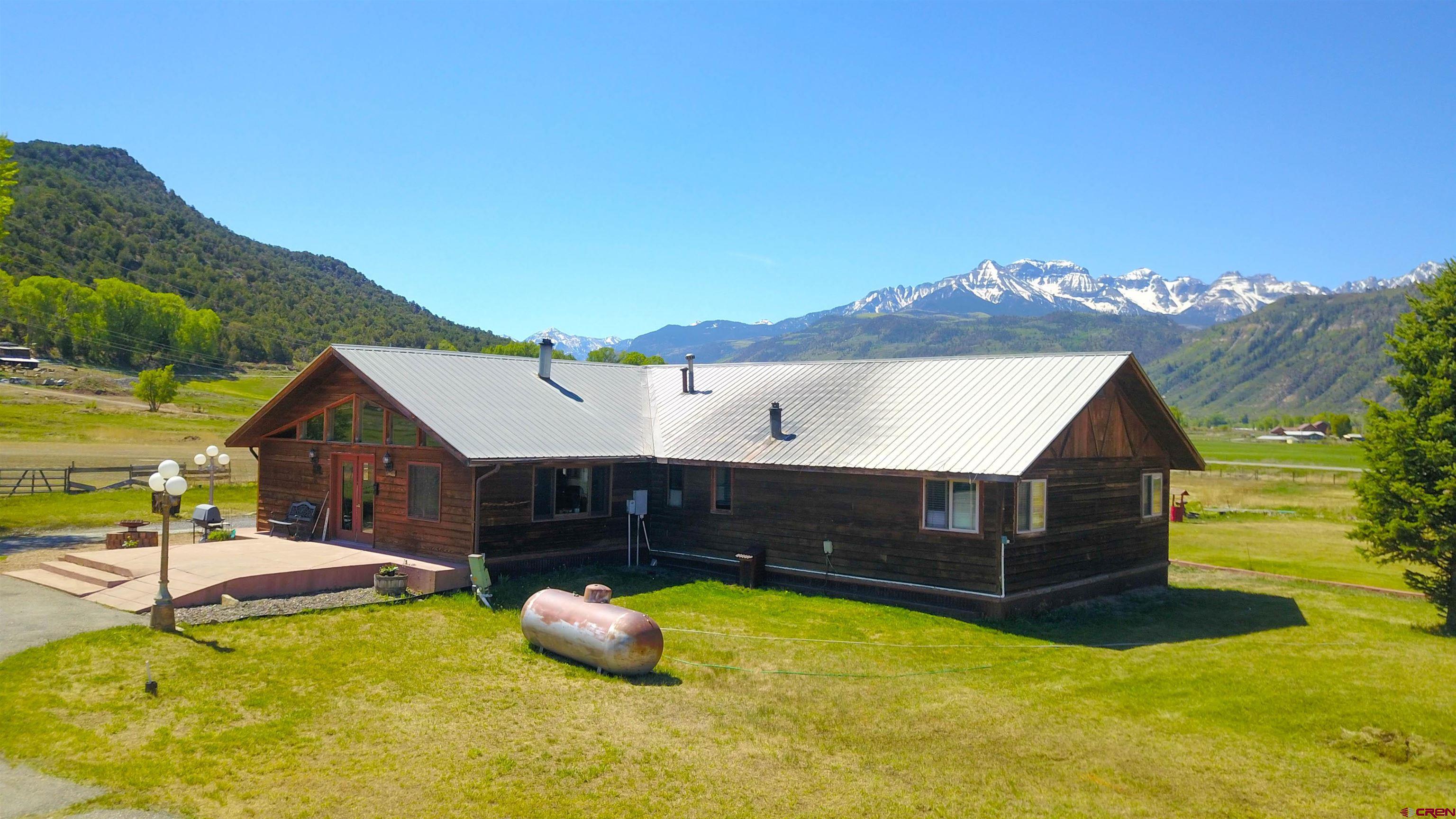 10 Acres just outside of Ridgway.  3 Bedrooms, 3 Bathrooms with main level living. 9 Acres of Irrigation with in your face Mt. Sneffles and San Juan views. 80 ft x 100 ft shop with plenty of room for all of your toys. No Covenants or HOA allowing one to do what they please. Propane Forced Air heat, along with back up coal fired furnace and wood burning stove. So many potential uses for this property!