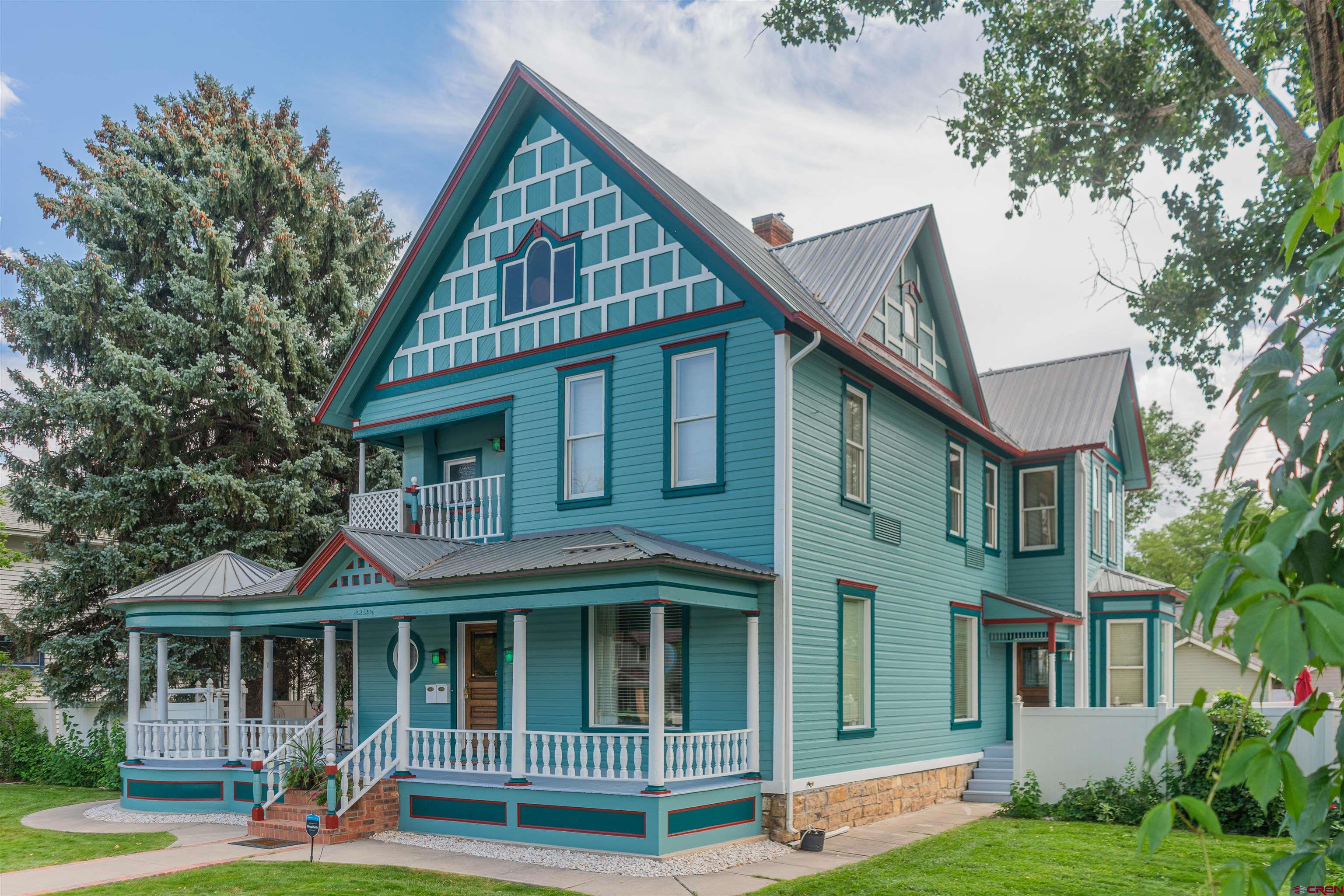 AN INCREDIBLE OPPORTUNITY AWAITS YOU TO OWN A HOME WITH  HISTORIC CHARM IN THE HEART OF DOWNTOWN MONTROSE,CO.  Originally constructed in 1902 for J.V. and Emma Lathrop's family, this architecturally impressive home embodies a period of Montrose history. The Lathrop House was listed on the National Register of Historic Places in 1988 and is one of Montrose's most well recognized buildings on Main Street with its beautiful architecture and simple classic lines. This Victorian home was the most expensive built in the town around the time of construction and the largest.  Today, this home boasts 6 bedrooms and 5 baths total, with several living spaces, an office, a formal dining room, chef's kitchen, 2 built in fireplaces and a beautiful wrap-around porch designed by Emma Lathrop herself. It is currently split into 3 different apartments with separate entrances but can easily be utilized as a Bed & Breakfast as it was previously. The attention to detail from the columns and scrollwork to the wallpaper and stained-glass windows throughout in this home are a must see. Schedule a tour today! The House comes fully furnished with the exception of personal items. A list of these items to be provided by Seller before closing.