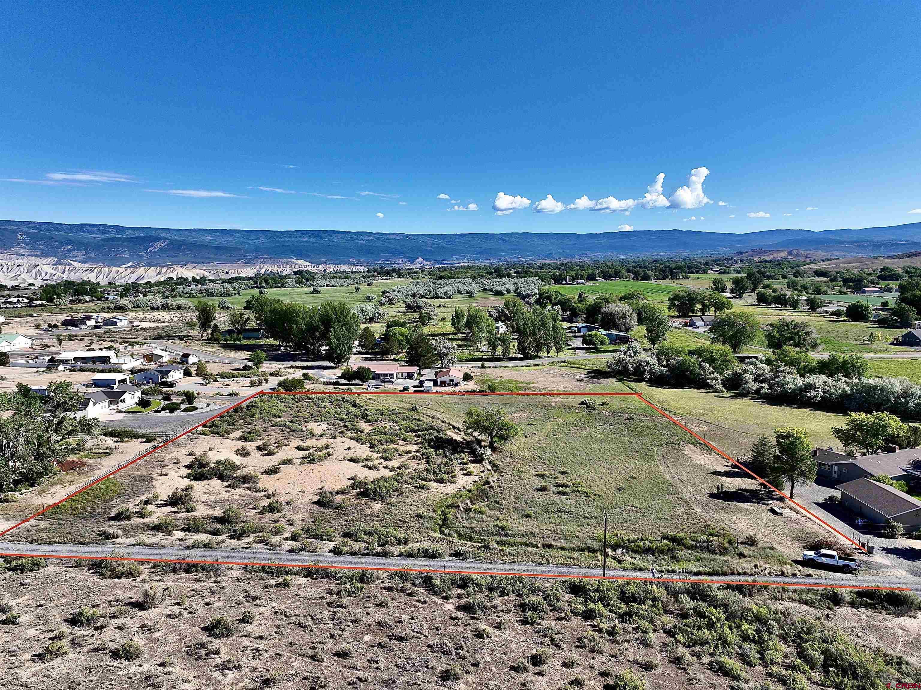 Small acreage in Delta County is hard to find and even tougher to find a property with irrigation water. Come build your home on this nice piece of land. This 4.91 acre lot is accessed on a private road. There is a great building site above the ditch on the western high side of the property that has some mountain views to the south east and north. The native grass and shrubs are still covering this lot and it is virtually untouched. Shape this into the property you would like. There is one Orchard City Domestic Water tap included. Survey has been done and plat is included in documents.   With the 1 share of Orchard City Irrigation Ditch and 3 shares of Butte Ditch water you can grow some pasture and keep the yard nice and green. Ditch runs right through the middle of the property and with a pump you could water your lawn or grow some pasture above the ditch as well. With no covenants build a shop for your toys or a barn for your livestock. Grow some fruit trees or a sweet garden. The surrounding properties are small acreage properties.   The Grand Mesa and all that it has to offer for outdoor recreation is only a 20 minute drive away. Delta is only 15 minutes away and has all your shopping, health care and necessities.