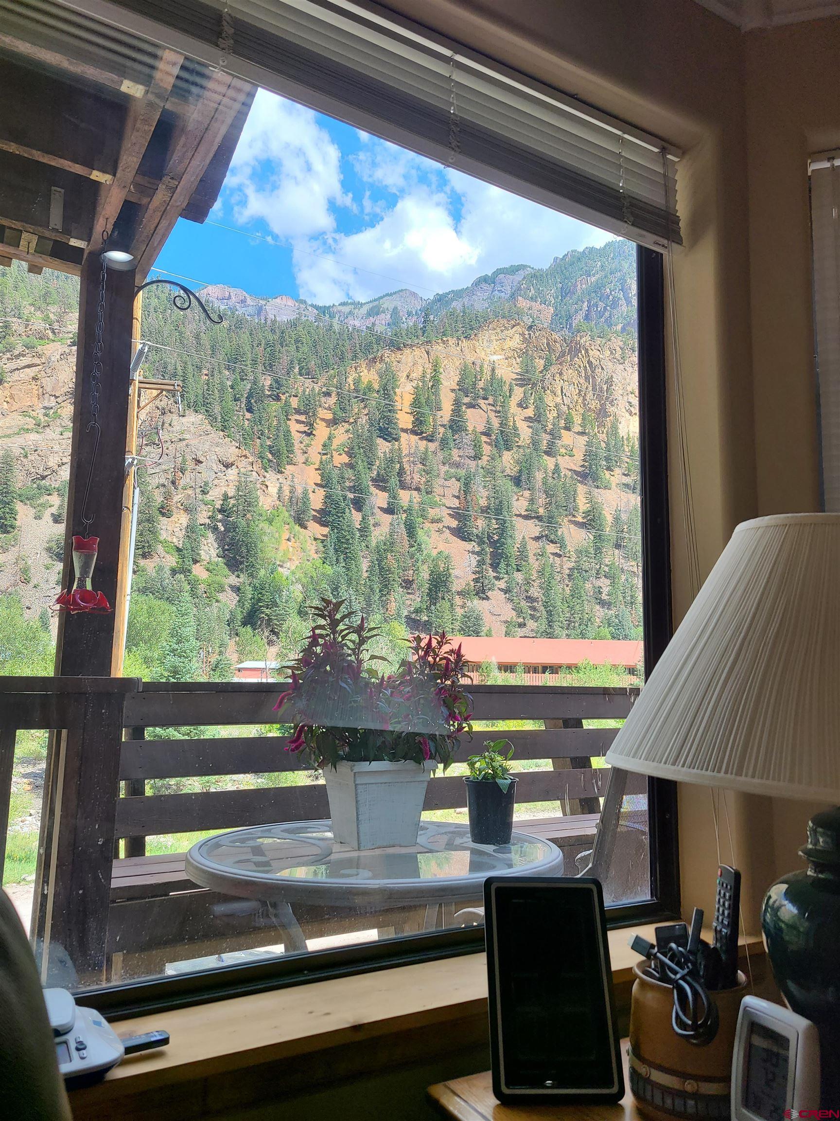 Two bedroom condo with a garage available for short term rental or delightful residence. All new appliances, flooring, cabinets, furniture in 2019. In addition to the front deck, there is a back patio and barbecue with shade in the afternoon. Beautiful and ready to move right in. Located in North Ouray with views of the mountains and the river trail right across the street. Furniture is available for an additional price.