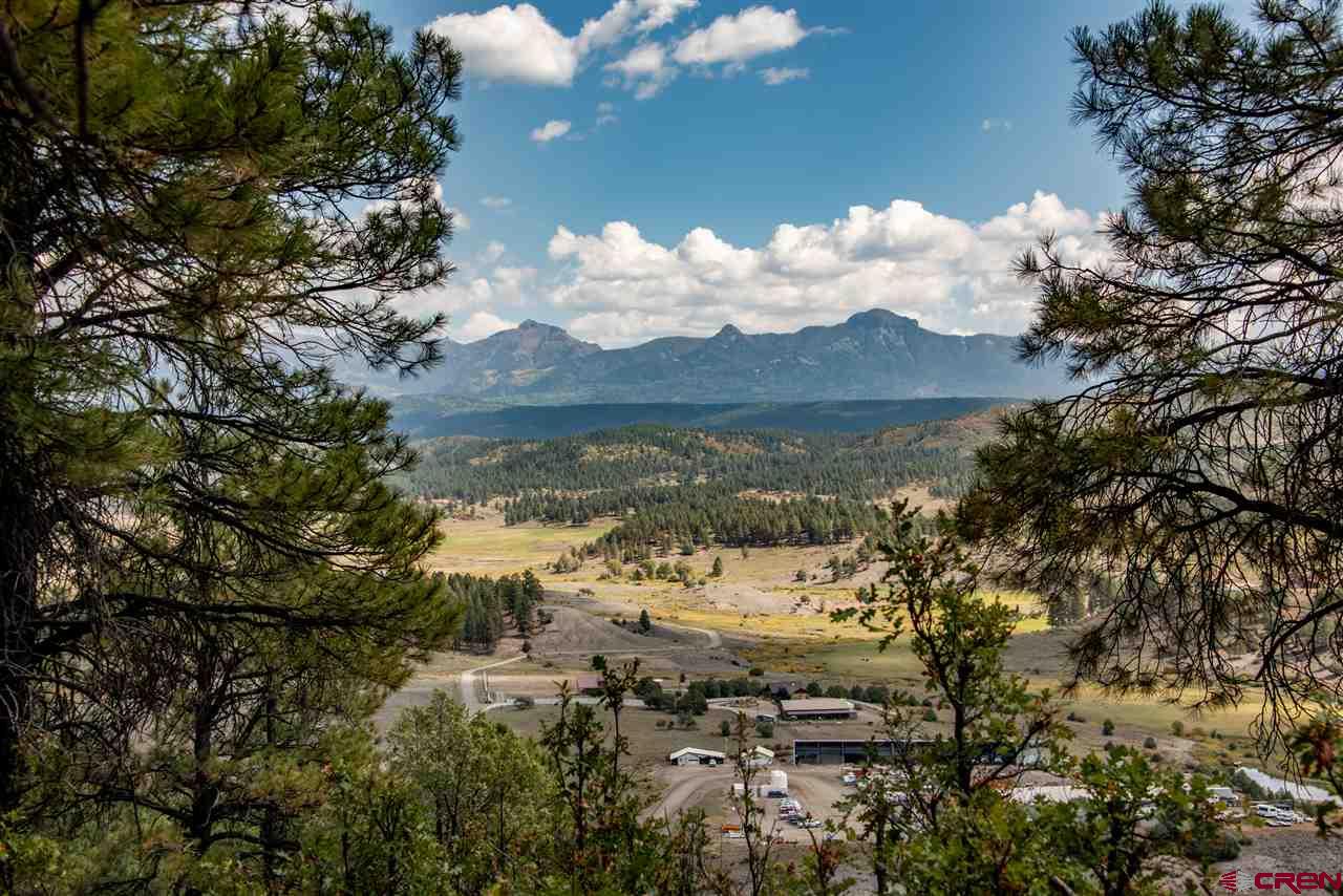 Located in the charming mountain town of Pagosa Springs, CO, Reservoir Ranch presents the unique opportunity to purchase 492+/- acres in a highly coveted location for use as a private residential ranch property or a County-approved mixed-use development opportunity.  Within walking distance of the famous Pagosa Hot Springs and all downtown amenities, Reservoir Ranch offers a rare combination of accessibility and serene privacy with staggering mountain views, lush, irrigated meadows, creeks and ponds, fencing and miles of access roads and trails for hiking, biking, ATV’s and horseback riding. This Pagosa Springs real estate property also enjoys ownership of extensive documented senior water rights from multiple sources. While the property can be retained as an amazing private ranch, it has the benefit of a transferable Development Agreement with Archuleta County, providing for long term vested development rights extending through September 1, 2034.  The vesting allows for potential development of 900 +/- units in total (less the allocations to parcels not included in the subject offering) and some mixed uses.  A copy of the Development Agreement and accompanying conceptual development plan is available upon request. Utilities available. Recognized and awarded by the State of Colorado for top-tier forest Stewardship, conservation and fire prevention practices on the property, ownership has also documented research into the possible use of geothermal resources for power and greenhouse support. This rare property offering and its various development parcels are available in bulk sale, but ownership would consider the sale of individual development parcels with appropriate pricing allocations.  Please contact Brokers for maps, development documentation and additional information on this unique opportunity.