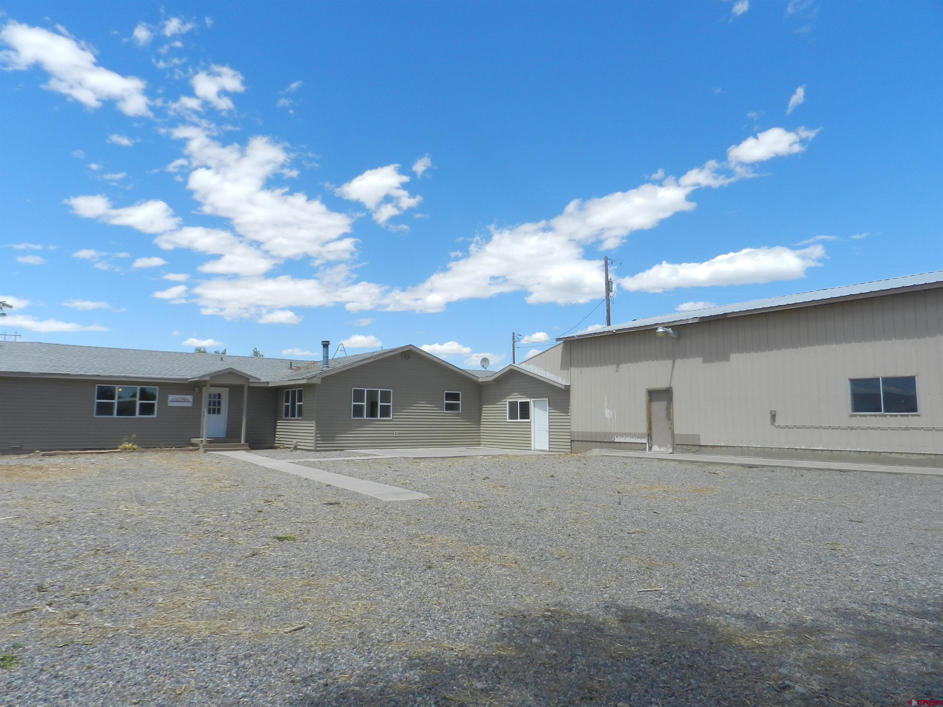 7.02 acres (MOL) commercial property located just off Highway 50/North Townsend Ave. Building is 5,307 sq.ft (MOL) and includes newly painted office space, storage and a 1,500 sq.ft. (MOL) warehouse/shop as well as a large graveled yard space. Zoned B-3 within the City of Montrose provides a variety of possibilities; construction/contractor services, limited manufacturing, building material sales and storage. Shop has one 10’ x 10’ and one 12’ x 12’ automatic overhead door. Easy access from Highway 50/ Highway 50 frontage road. Other facilities in close proximity include Montrose Regional Airport, UPS, Montrose Daily Press, FedEx and Delta-Montrose Electric Association (DMEA).
