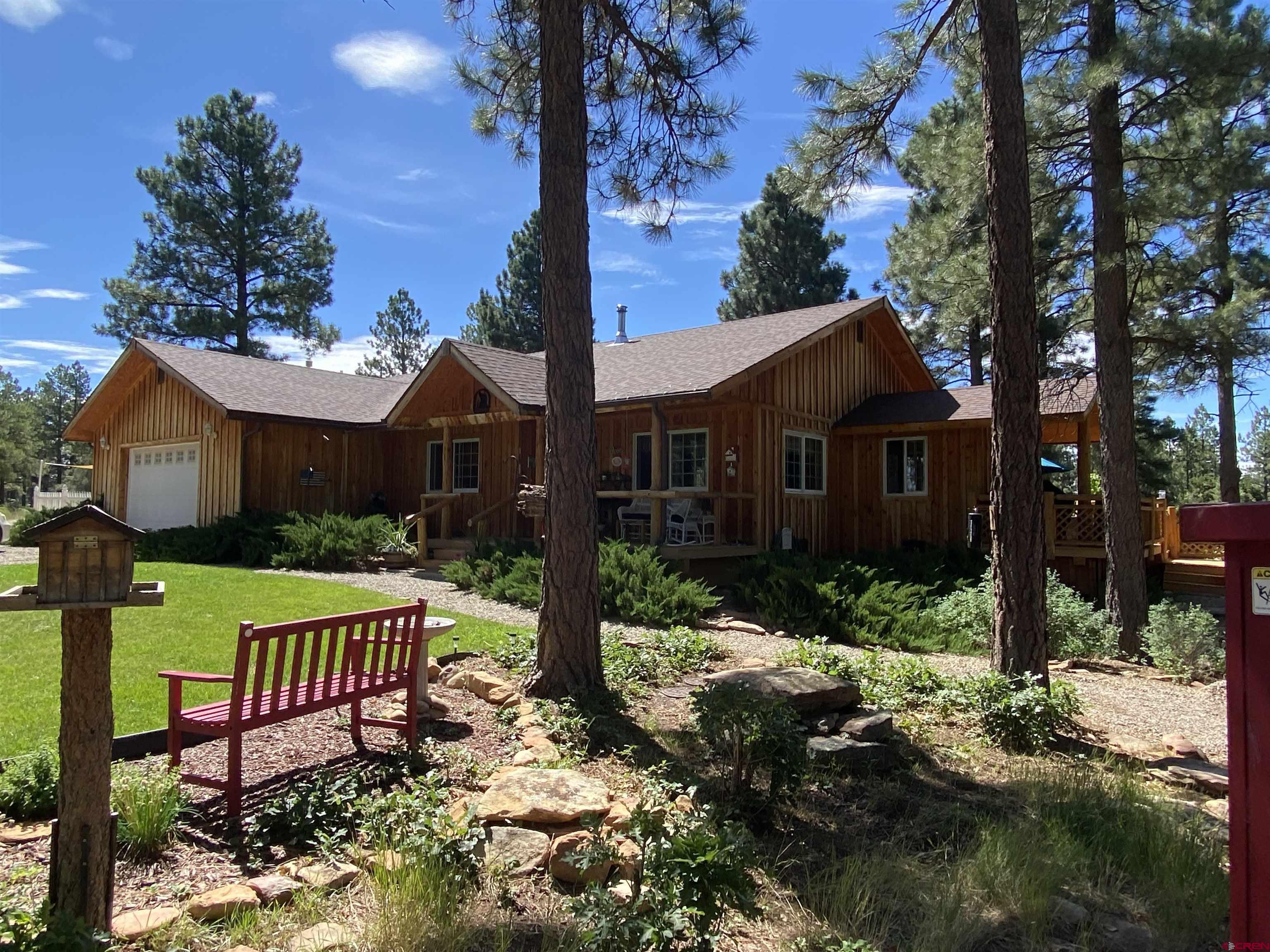 The wait is over for your private mountain retreat tucked away in the ponderosa pines of Colorado. When conversations come up about moving to your own private spot in the mountains with fresh air, pine trees and tending to your own garden, well there is such a place. There is a private graveled road taking you to the top of this 4.37 acre property. The main house has a covered front porch and wrap around back porch to enjoy the morning sunrise or to cool off in the afternoons. Lots of attention to detail went into the building of this home. This three bedroom, two bath home has a formal dining room, white washed aspen walls, red oak flooring shipped in from Canada, vaulted ceilings, butcher block island, a Thermador professional range with an exhaust fan that could suck the toupee right off your head. The south side of the home has a great sun room to relax and take in the warm sun on a cold winter’s day. The master bedroom has an en suite with a large dressing area and walk-in closet. If you don’t feel like using the forced air heater there is always the cozy wood burning stove. The property also has a secondary home and there is potential for rental income, as an Airbnb, or perfect as guest quarters. It is a three bedroom, two bath “barndominium” built inside the 64’ x 40’ barn. The barn has a ton of room to store your toys or equipment all year long, plus a heated workshop. There are two separate septic tanks for each living quarters. If you plan on gardening or have horses, there is plenty of space on the property with a ¼ acre fenced in area.  Pride of ownership is the best way to describe this Colorado property. It is conveniently located near Cortez, Dolores and Mancos in the desirable Summit Ridge area, plus access to thousands of acres of the San Juan National Forest, Mesa Verde National Park, McPhee Reservoir, Summit Reservoir, biking mecca Phil’s World, and so much more. Come view this rare find in Southwest Colorado!