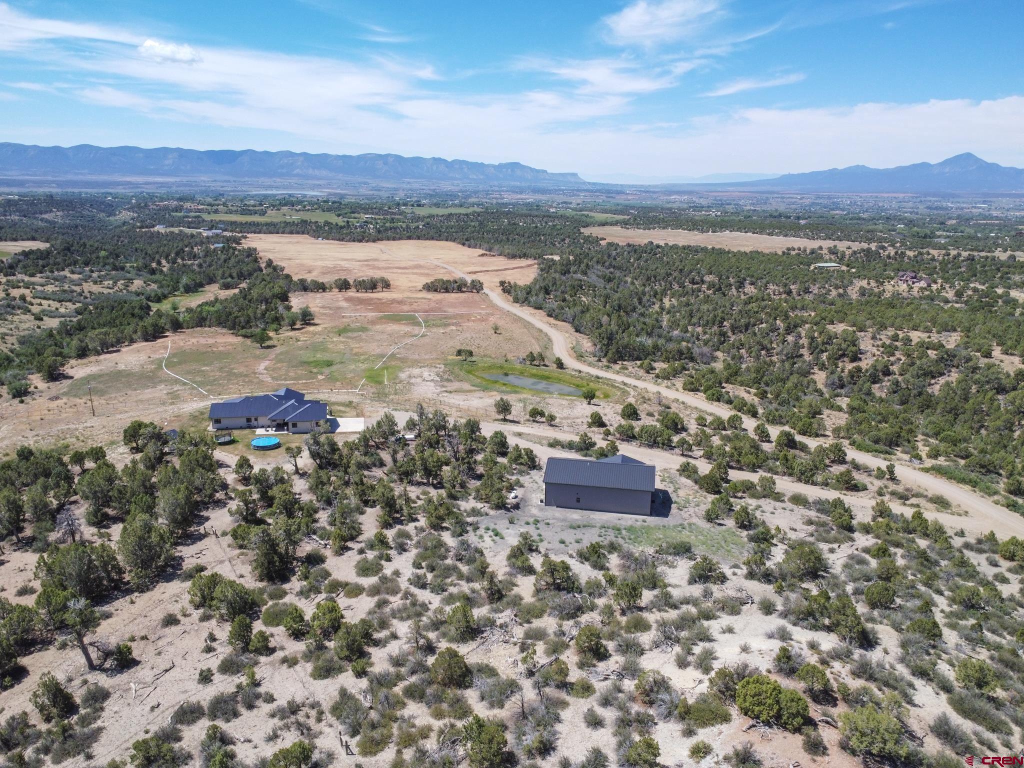 “On Top of The World” is how to describe this exceptional property with breathtaking views of Southwest Colorado!  Where to begin… this 35 acre property is located in Black Rhino Ranch subdivision enclosed with a custom piped-cabled fence around the entire property.  Flood irrigation system is setup with irrigation water rights including one share of Summit Irrigation.  This ranch style custom home has everything you would want and more.  This 4 bed / 2.5 bath 2800 + sq. ft. home has many highlights with custom stamped concrete sidewalks and a covered front porch to sit and enjoy those tranquil Colorado sunsets. The floor plan is open and inviting with high ceilings, custom laminate flooring and carpet in the sleeping area’s of the home.  Kitchen is equipped with Samsung appliances, custom satin granite with Crestwood cabinetry.  The master bedroom is located on the east side of home to capture the morning sunrise with an oversized walk-in closet and en suite master bathroom.  Enjoy a soak in your Gloria free standing tub or have extra room in the walk-in rock floor double head shower.  If you have animals you would like to bathe, well they have their own shower too, located next to the double car attached garage.  No need to haul around hoses and sprinklers all day, because the property is set-up with Rain Bird underground automatic sprinkler system.  Let’s not forget about the shop and “Man Cave” just built in 2021.  Custom cars, boats, campers, and all-terrain vehicles can all be stored in the 40” x 40” heated garage with epoxy concrete floors for easy clean-up.  With the shop comes your very own “Man Cave” to entertain your friends with a game on TV or a night of poker.  The shop also has instant hot water heater, bedroom, bathroom and extra storage space.  There are two separate septic systems for the home and shop.  You may never want to leave this property, but keep in mind you are conveniently located to great outdoor recreation areas like Telluride, Durango, Moab, Mesa Verde National Park, San Juan National Park, McPhee Reservoir and Phil’s World.