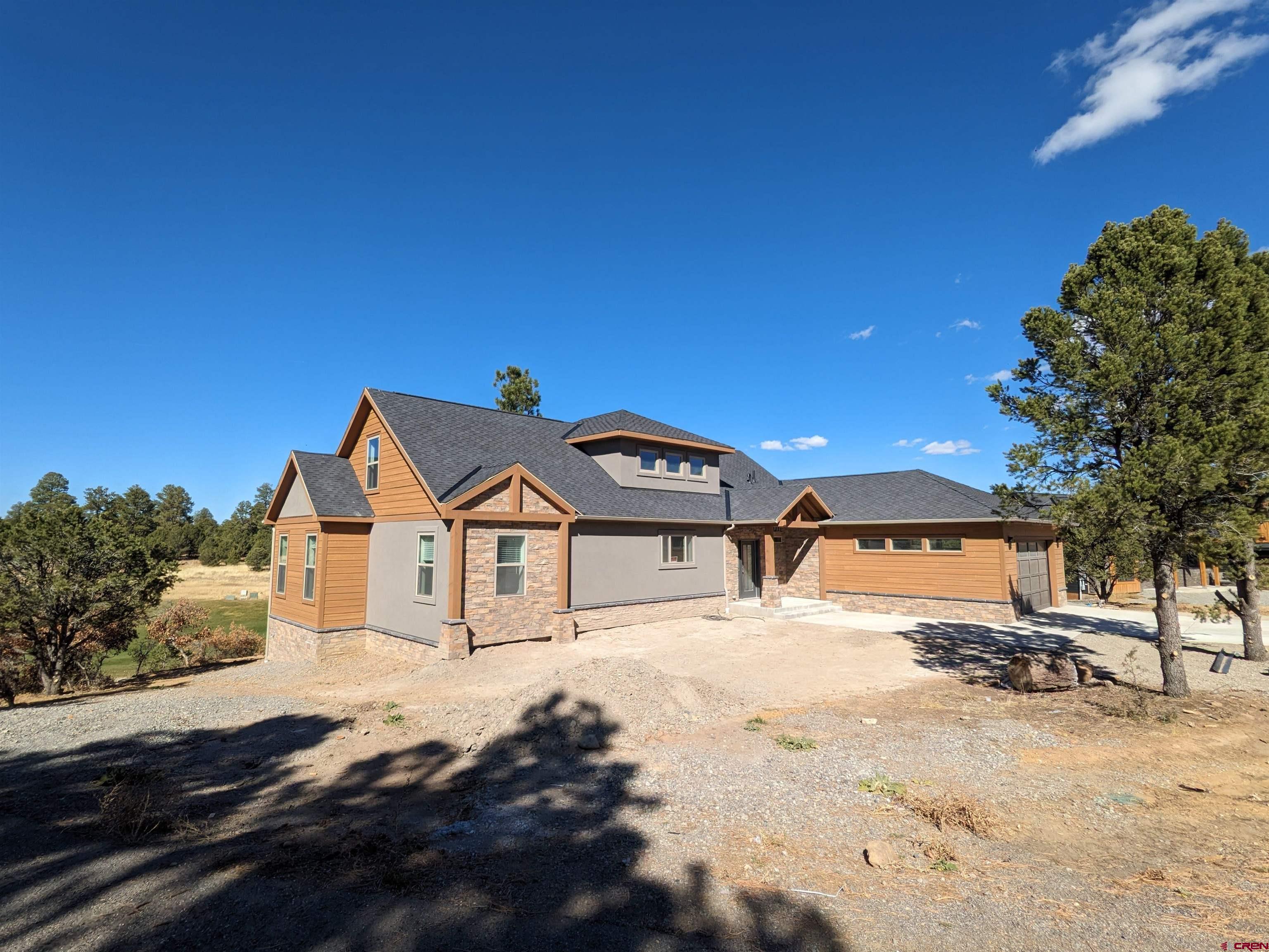 This newly built 4 bed 3 bath home is a true gem, offering luxury and comfort in a tranquil and serene setting. Located just an hour from world-renowned Telluride skiing, this home offers the best of both worlds - adventure and relaxation.  As soon as you walk in, you'll be greeted with beautiful stone countertops throughout, adding an elegant touch to this stunning home. Large windows throughout let in an abundance of natural light and provide breathtaking views of the surrounding scenery, making you feel as though you're living in your own private oasis.  One of the standout features of this home is its lot location, which backs up to a picturesque golf course at the end of a cul-de-sac. This peaceful and private space is perfect for spending time with family and friends, or simply unwinding after a long day.   The 4 spacious bedrooms and 3 luxurious bathrooms provide ample space for a growing family or guests, with each room designed to provide maximum comfort and privacy. The master suite, in particular, is a true retreat, offering an inviting and peaceful space to relax and recharge.  In addition to its beautiful interior, this home is located in an idyllic and peaceful setting, offering a sense of privacy and serenity that is hard to find. This unique opportunity to own a piece of paradise is not to be missed. Contact us today to schedule a viewing and see for yourself why this is the perfect home for you.