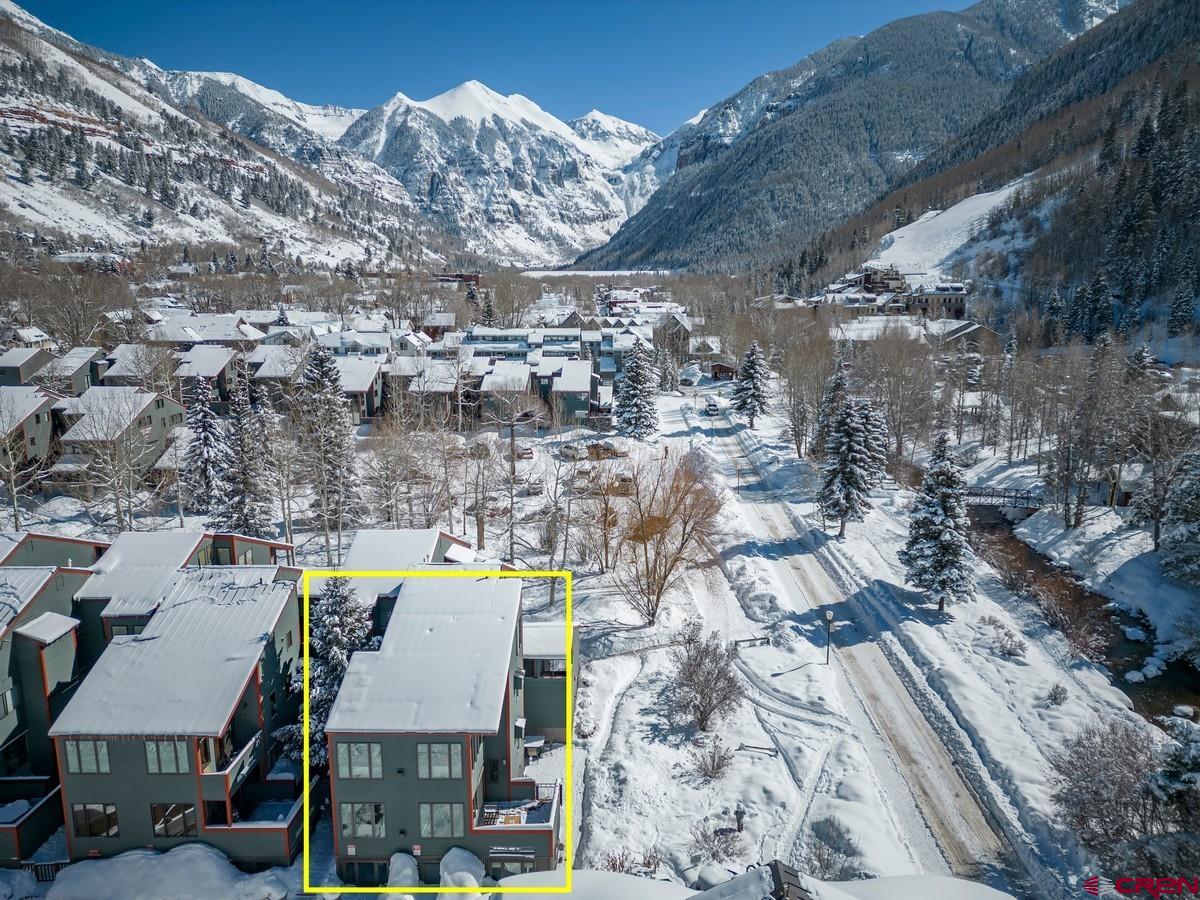 This is what you’ve been waiting for!  The rare opportunity to own arguably the best location at Telluride Lodge! Telluride Lodge is known for its premiere ski access, spacious floorplans, outdoor space and lower homeowners dues.  This completely re-engineered property is located at the southern corner of the 500 building and a unique opportunity to own the entire corner. This offering consists of two separate but connected turnkey condominium residences. The property can be used as one large compound or use one and rent another or rent both. No detail was overlooked during a complete top-to bottom redevelopment and expansion by Richardson Construction. Positioned directly across from Coonskin/Chair 7 and San Miguel River Trail, steps from the market and Davis & Pacific Street restaurant and shops.   Unit 541 is a well appointed residence of approximately 1,345SF. The main level has a chef’s kitchen, open living and dining areas with gas fireplace which opens to a spacious outdoor deck presenting ski area and box canyon views. Step down into a bright primary bedroom and ensuite bath with steam shower.  The lower level offers a laundry room, owner storage, well-designed bunk room and steam shower bathroom.  The third bedroom with bath on suite has shower/soaking tub combination.  Features include coffered ceilings; concrete, durable laminate and carpeted in-floor radiant heated flooring.   Unit 542 is approximately 1,236SF with three levels of elevated views, light and luxury appointments.  The upper most level is currently set up as office/flex space which can be reconfigured for additional sleeping space.  Extensive owner storage and a laundry closet are on this top level . The mid-level has a queen bedroom with vaulted ceilings, south-facing sun and tremendous views of the ski area.  A ¾ bath with custom built-ins and steam shower accommodates guests. The primary bedroom has thoughtful built-ins for two, east-facing views through a large picture window and ensuite bath with additional built-ins and steam shower.  This main living level has the same appointments, chef’s kitchen with open concept living/dining areas, gas fireplace and featuring vaulted ceilings, spectacular light and mountain views.    Telluride Lodge Location/Amenities:  Along Galloping Goose Town Shuttle Loop Directly Across from ski lift Across from San Miguel River and River Trail 5+ acres of greenery, shared grills/picnic table Mountain Views Steps from restaurants, shops, ski rentals Common hot tubs & spa facility  Residence Amenities: Completely remodeled from the studs by Richardson Construction with insulation, drywall, in-floor radiant heat, recessed lighting, fire suppression, AV/data wiring,  Gourmet kitchens with custom milled alder cabinetry, solid surface countertops, stainless  Appliances include Thermador gas island cooktops, Thermador & Bosch wall oven/microwaves; Bosch dishwashers, wine coolers. 2 GCE parking spaces Hallway ski storage and multiple interior owner storage closets Spacious deck looking up to ski area and east to Gondola and Box canyon  This property does not have a Town of Telluride STR license, is not rented and is in beautifully maintained condition.