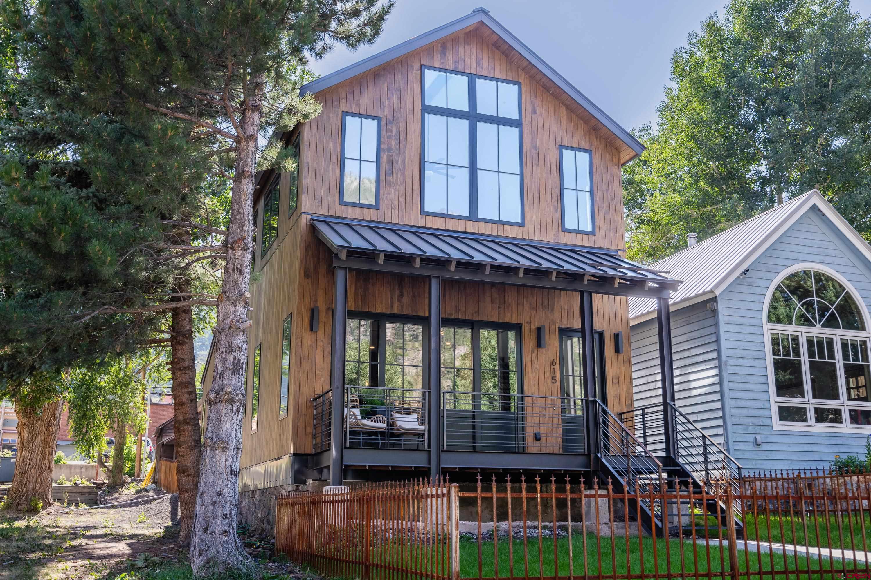 Located in the heart of downtown Ouray, come see this mountain modern home that blends functionality, unmatched views and design. This exceptional home was inspired by the surrounding mountains and effortlessly frames the iconic Cascade Falls in almost every room. The open floor plan and indoor/outdoor living make this an entertainers dream. The master bedroom is located on the main floor with a custom ensuite and an attached patio to sit and enjoy the amphitheater views.  With 2 bedrooms, 1 bathroom and a media room upstairs there is plenty of space for your guests. There is custom steel accents throughout the home by local artisan Skol Studios.  The home itself is something to relish, its flawless mountain modern design highlights the preeminent views while ensuring every space is functional & inspiring. If you are looking for a short term rental, this home is already furnished and ready for your guests! Come check it out today.