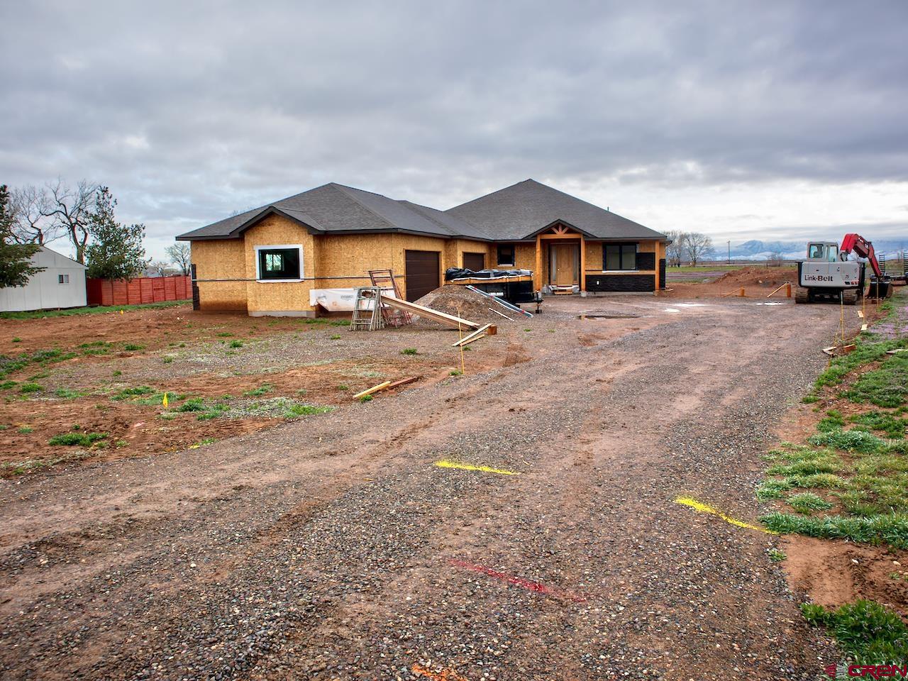 Have you desired to live in the country? This custom, newly-built home is almost completed. Solid workmanship and design, originally intended to be builders retirement home.   Real 3/4" Maple floor throughout, title in the bathrooms and laundry, with carpet in the bedrooms. Gorgeous kitchen with painted modern grey cabinets and a huge walk-in panty. Fantastic mountain and valley views to the east and north. Step out on the 390SF rear covered patio to enjoy the solitude. True great room is spacious and ready for entertaining.  Four bedrooms, and three full baths. The primary suite has a walk-in closet that truly has all the room you'll want, a large step in shower with no need of glass door, and a large free standing soaker tub to indulge.   The 1600+ garage fits four cars and all your toys. Sitting on 1.5 acres with irrigation in the lovely Twin Springs Subdivision.