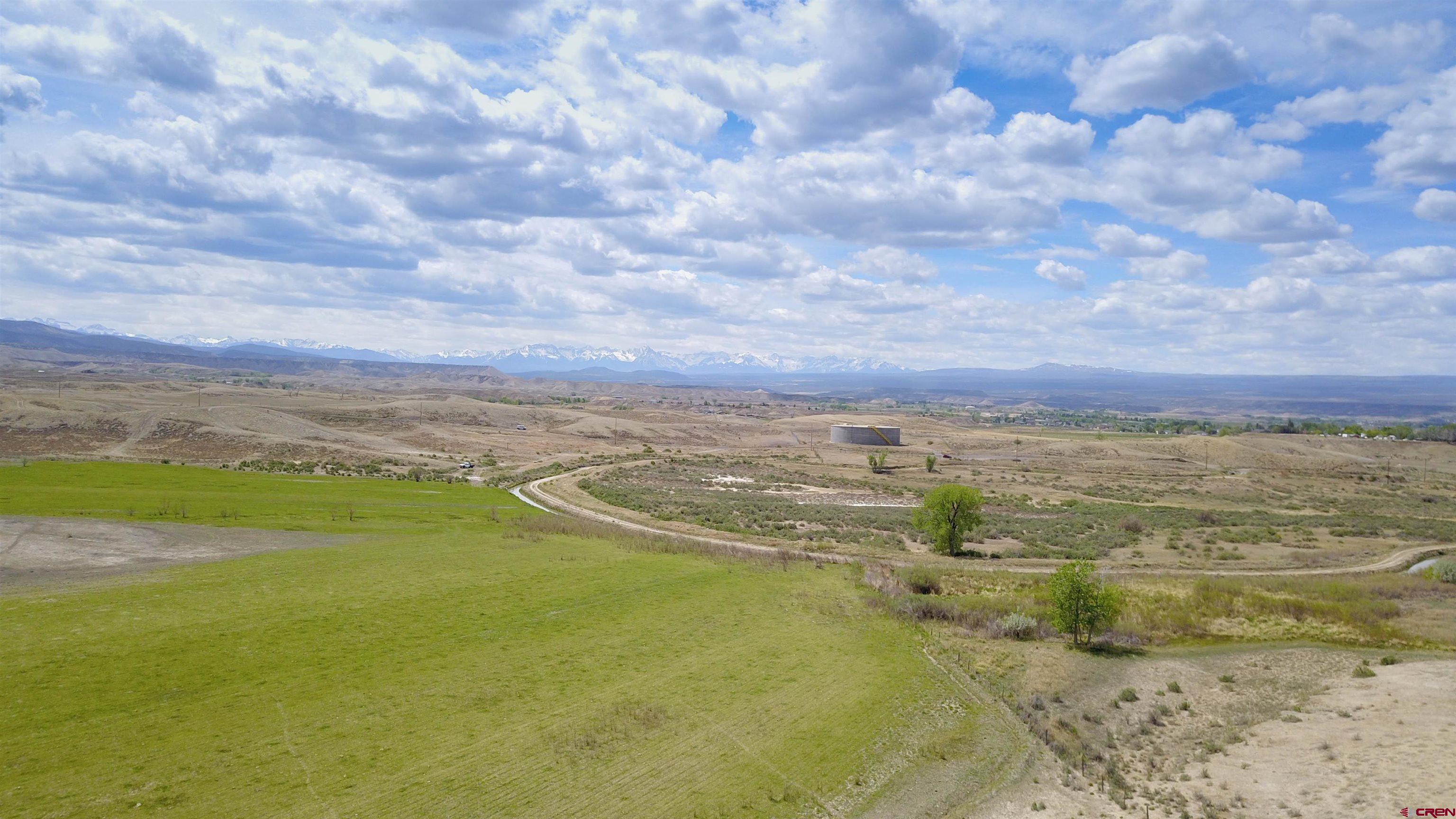 Development opportunity right in the City of Montrose! Tract 1 of Circle H Ranch offers 123 acres with 17.3 fully irrigated. Currently this beautiful acreage provides a home for livestock.  Some of the acreage is in hay and has been farmed for years. Are you looking for a gentleman’s farm/ranch not too far out in the country?  This is it. Alternatively, in the past, this property was platted and approved for a residential subdivision as well as 10 full acres of B4 commercial zoning.  Any new developer will need to repeat the process but it’s a great chance to add your permanent stamp to the City of Montrose.  This Tract 1 includes ag land which had been approved for R1A zoning – i.e. one home per every half acre – these homes would each have spectacular views.  Installed city sewer line is included, $96,000 paid toward sewer taps and the entire property can access sewer – no septic required.  Tri-County Water taps are available and all utilities are to the property line.  You will NOT find a better opportunity in the future.  Montrose is growing and expanding and this is great time to start your development!  This versatile property has options – contact me today for all the info!!