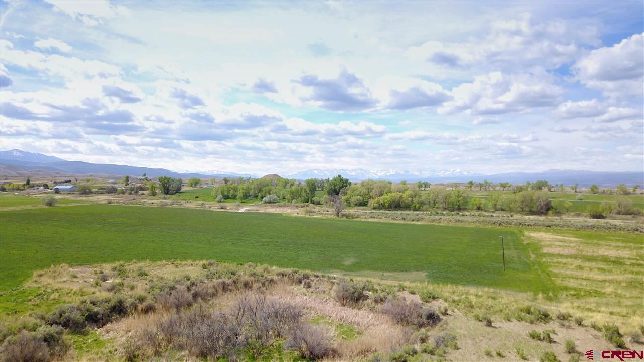 73 vacant acres located with Highway Frontage in the Highway Corridor.  70 fully irrigated acres which are in hay.  Excellent land for livestock, which is the current use.  This tract has Highway 50 frontage which provides easy access for future use.  Whatever your purpose for purchasing this acreage (ranching/farming or development) this is prime land – a rare find in the Highway Corridor along with Commercial/Residential potential.