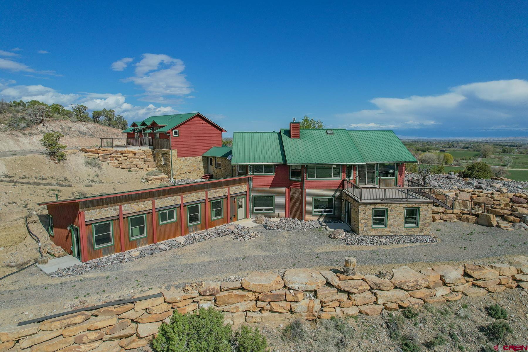 2022 Remodeled Country Home on 15 Acres For Sale:  Located at the end of 6300 Rd in a serene and private area to the SW of Montrose, this 5,109 Sq Ft home sits on a gorgeous and picturesque view point with 15 acres. The home, named "Skyline Ranch", was remodeled in 2022 with high end finishes including engineered hardwood flooring, Knotty Alder trim and doors, all new appliances, as well new siding, windows, and roof to the homes most recent addition. There is no shortage of storage space, and plenty of options to furnish the 5,000 Sq Ft home as you please. The entire house is heated using in-floor radiant heat, and the master bedroom does have central air conditioning. The open concept living room / main level truly offers some of the best views with a generous amount of large windows. From the Grand Mesa, The Cimarron Mountains, San Juans Mountains, and Downtown Montrose, it really is spectacular and yet only 10 minutes from Main Street and Montrose / Telluride airport. The property is mostly dry, but does have mature vegetation, a small pond that wildlife use, Aspen trees at the front entrance, and a lovely water feature that welcomes you to the home. The house also overlooks a private airstrip with the opportunity to purchase a building lot on the actual airstrip.There are also neighboring parcels for sale from the same owner.   Borders BLM (GMU 62), Cul-De-Sac, Large Workshop, Fiber Internet  Being one of the original homes above this small airpark neighbor (Ranger Ranch Airstrip), it has some of the best access to BLM public lands and the opportunity to own property on the actual airstrip. It is a dirt runway, perfect for larger tire backcountry planes, and STOL pilots. There are several hangars built next to the runway and aviation enthusiasts nearby. The 15 acre property does have a large heated shop that was built in 2000 and has concrete floors and plumbed for a bathroom. There is an ample amount of space and parking on the property for recreational toys, RV, or Camper. The home does have a brand new septic system adequate for a 5+ bedroom home, well water that is clean and pumps strong, as well Elevate fiber internet. There is strong cell reception and LTE service.   Montrose, Colorado - Hiking, Biking, Fishing, Rafting, Big Game Hunting, Skiing, Snowmobiling Montrose Colorado is a growing Western Colorado town known for its easy location, warmer climates, and abundant recreation. Just down the road is Ridgway and Ouray, Colorado - known for their famous hot springs, mountain climbing, and small mining town charm. A little farther down the road is Telluride & Telluride Mountain Resort for the summer and winter extreme sport athletes. Montrose, Ridgway, Ouray, and Telluride also have fine cuisine, local bakeries and coffee shops, and plenty of community events year-round. Moab, Utah is also a commonly visited town that is a scenic drive west and within 3 hours. The Grand Mesa is just north of Montrose and one of the largest flat top mountains in the world, offering over 300 lakes and ponds. Montrose is surrounded by ample opportunities for off-roading, dirt biking, mountain biking, rafting, hiking, fly-fishing, and snowmobiling. This property in-particular has jeep trails, single track, and rock crawling within a half mile and accessible from your driveway. This home is set up perfectly for the recreational type, aviation enthusiast, big game hunter, or someone who just wants the best views you can find within commuting distance to Montrose or Ridgeway, Colorado.