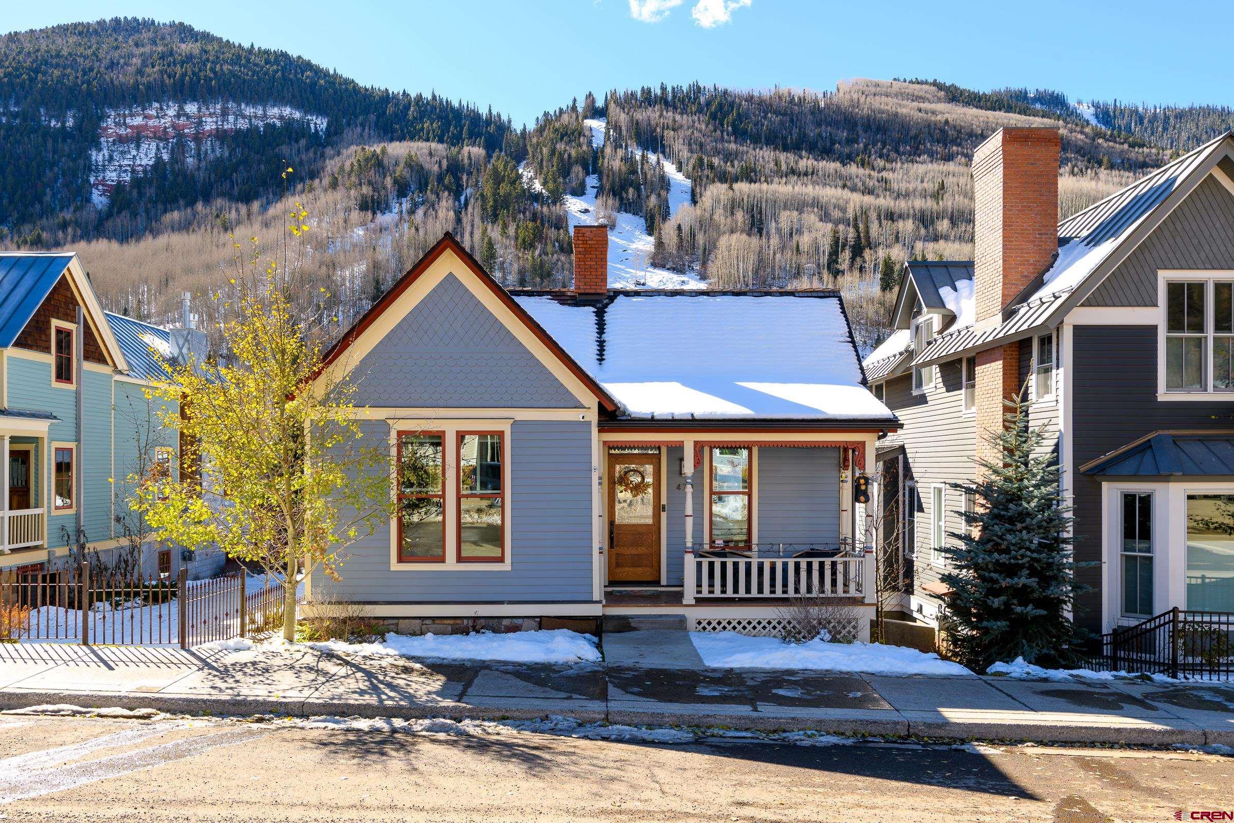 Nestled in the majestic San Juan Mountains, this fully refurbished and expanded 1892 Historic home offers stunning 360 views. The Main Street porch, a favorite spot for homeowners for 131 years, provides front row seats to enjoy the Magic of Telluride. Some things never grow old! Remodeled in 2018 by 'Jack Wesson, LuxWest Interiors, and Finbro Construction', the home features a spacious open living, dining, and kitchen area, which opens-up entirely to a large sun-kissed BBQ deck and hot tub. The views of Aspen trees, mountains and ski runs are spectacular! This incredible home boasts five luxurious bedrooms, four exquisitely designed bathrooms, a movie/cocktail lounge with a wet bar, two laundry rooms, and a heated garage and driveway.  The air-conditioned top-floor suite offers magnificent views and a private balcony. The house is equipped with a fire sprinkler system, security system, Lifebreath ventilation system and so many more amazing details. Located within walking distance to Main Street shops, dining, skiing, hiking, the valley floor, Bear Creek, and the Gondola, this fully furnished retreat is a dream destination for those who seek a luxurious mountain lifestyle.