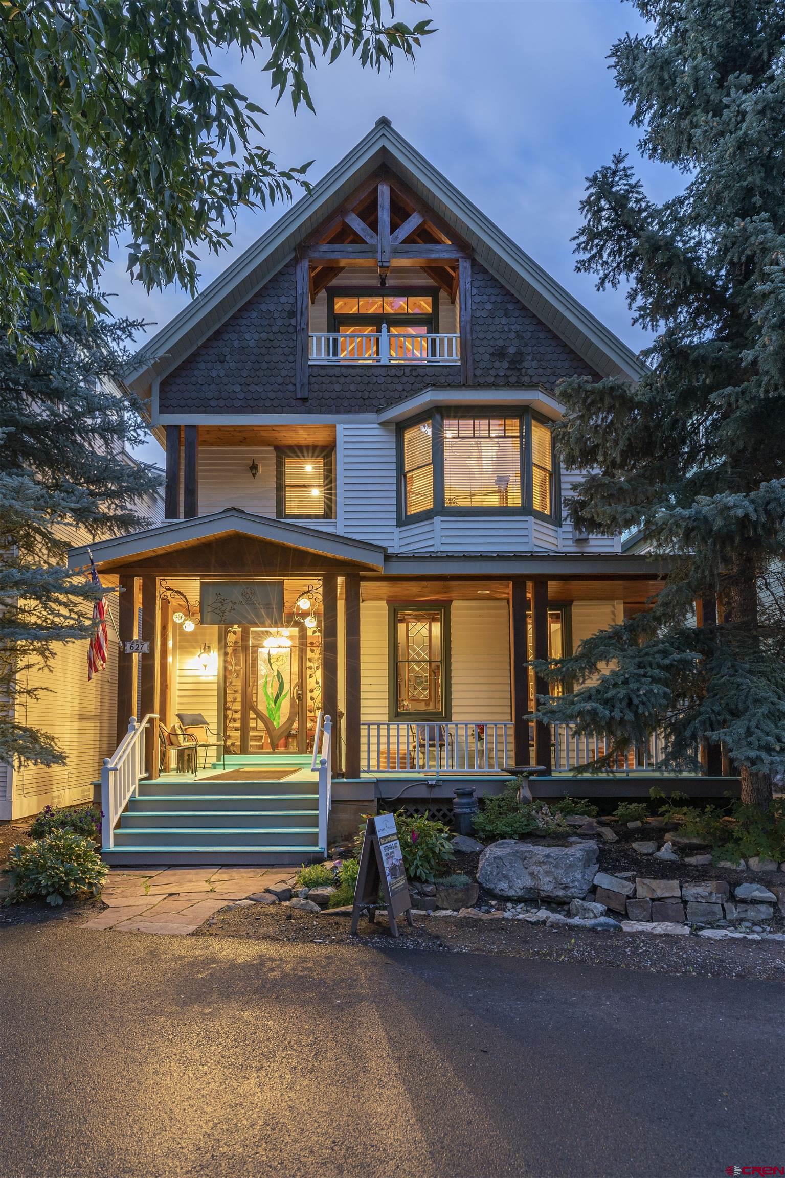 The perfect marriage of quality, location and space. This warm and sunny west end gem boasts 6 decks and 2 porches to enjoy the magic of the mountains from every vantage point. Four luxury suites were updated in 2019, each with ensuite baths. The open concept living/dining/kitchen with its vaulted ceiling, timber frames, gas fireplace, and hot tub deck is the quintessential mountain retreat while being steps from Telluride's vibrant downtown. A second kitchen and living area offers plenty of space for large families or remodel opportunity. Currently operated as the Wildwood Canyon Inn, this spacious residence has a transferable STR license. This home is truly your WISH come true!
