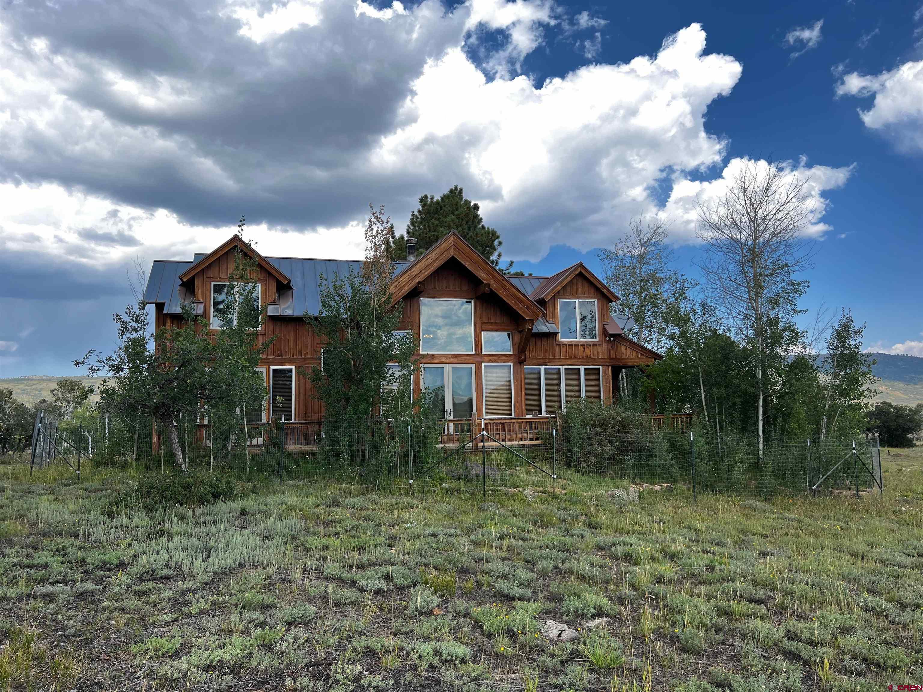 Comfortable and rustically elegant residence/ cabin situated atop one of the most pristine mesas in view of the majestic Sneffels Mountain Range. This offering consists of 6- 40-acre quarter section parcels that total roughly 244 acres. Located approximately 30 miles from Telluride and 17 miles from Ridgway. Spectacular meadows that open to unparalleled views. Seasonal surface ponds and a mix of trees and huge views. The timeless cabin is located in an ideal home site that takes in the beautiful Sneffels views, extraordinary sunsets and alpenglow. 2 bedrooms and a sleeping loft allows lots of room for family and/or friends. This is a rare opportunity for a spectacular legacy parcel.