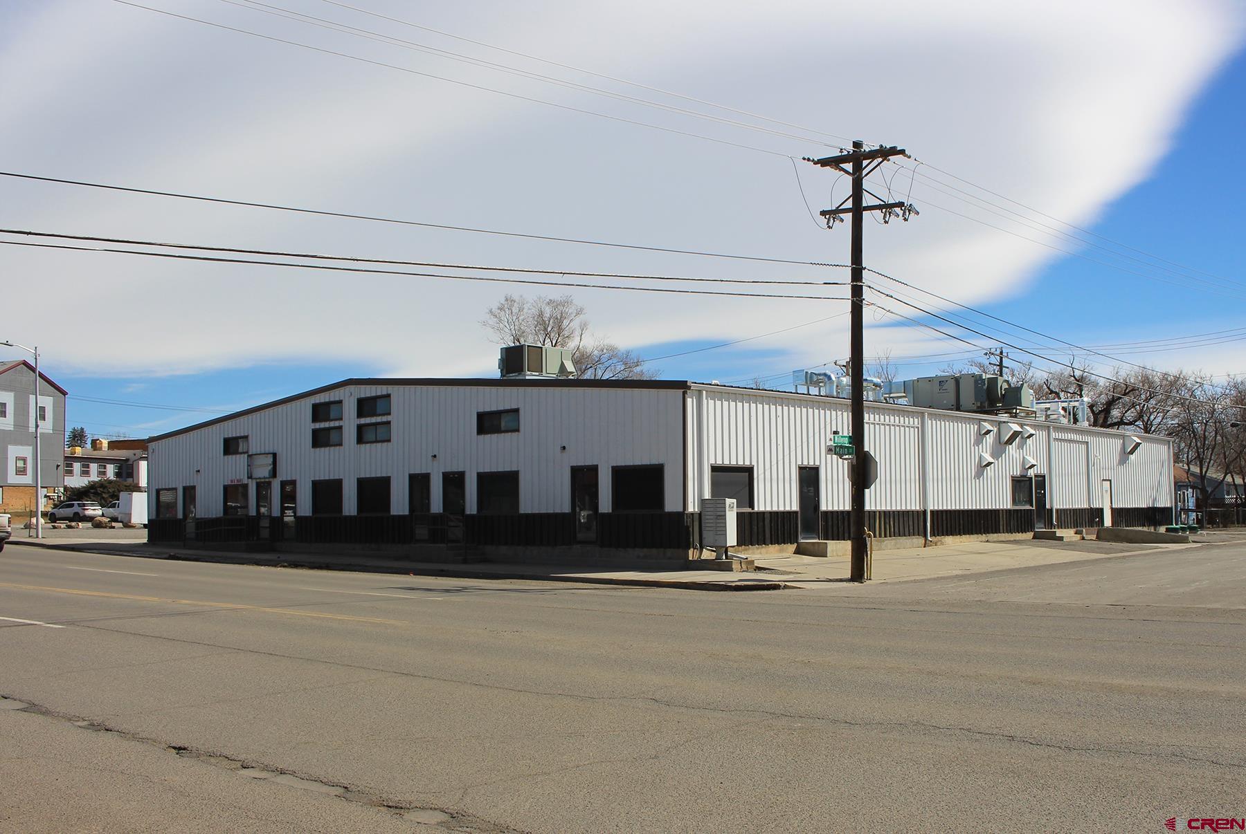 Large 14,699 SF MOL Commercial/Industrial building.  Most recently has been used as a pet treat production facility.  Favorable B-2A zoning allows for many different business types making this an incredible opportunity with both ample square footage and vacant land.  Amazing location for both Sales/Service type business (Central in town) or Warehousing/Distribution (Direct access to the main thoroughfares).  Serviced by 2" gas line, and 800 Amp electrical, energy infrastructure is already in place for almost any use.  Suitable for a single tenant or multiple.  The building could easily be split up and rented out to multiple tenants as it has been in the past.  Existing walls could be used to create various sized units.    Huge 17' ceilings inside.  3 existing overhead doors, of 7', 10' and 12' on the Parking Lot side.  There were also previously two 12' overhead doors on the Willerup Ave side that have been filled in, but could be re-converted by a new owner.  One is set up for a 26" loading dock.  All cold storage room walls and ceilings could be removed to create more area with full floor to ceiling height.