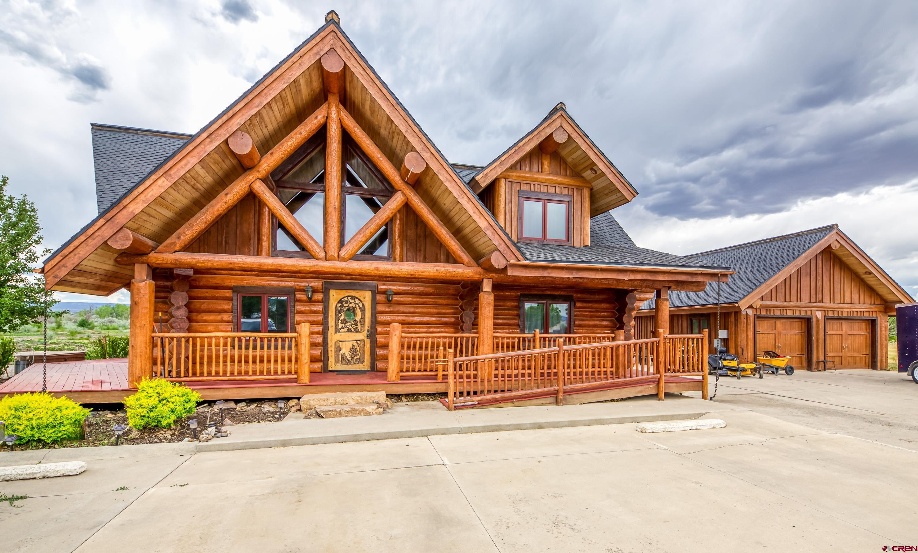 Extremely sought after location for a great business opportunity in Montrose Colorado. Beautiful log home sitting on 1.8 acres  Zoned B2, could be your chance to VRBO, BnB,  or run your business from this fantastic location.  With an ample 3300 sq ft of living area and a Detached 2 car garage with upstairs loft that could be converted into additional living space the options are abundant.  Gorgeous views of the San Juans from the property.  Vaulted ceiling with open loft and upstairs deck.  This home is located within walking distance to the River Walk Trail and Colorado Outdoors.   Large concrete off-street parking; located at the end of the cul de sac.   The logs have been stripped, re-stained and chinked in 2021.  The interior of the home is spectacular with hand carved walnut floors and plush carpeting.  The kitchen has Bosh appliances with an induction stove and gun metal stainless finish.  Custom kitchen cabinets and a rolling island for additional opportunities.  Gas fireplace ,Steam shower, 2 person hot tub, handicapped entrance, quiet private location.   Finished basement that is currently leased on a month to month basis.   The zoning of this property creates an environment with endless opportunities.  The 1.8 acres leaves room to expand commercially or personally.    Come take a look at this property and seize your entrepreneur dreams.
