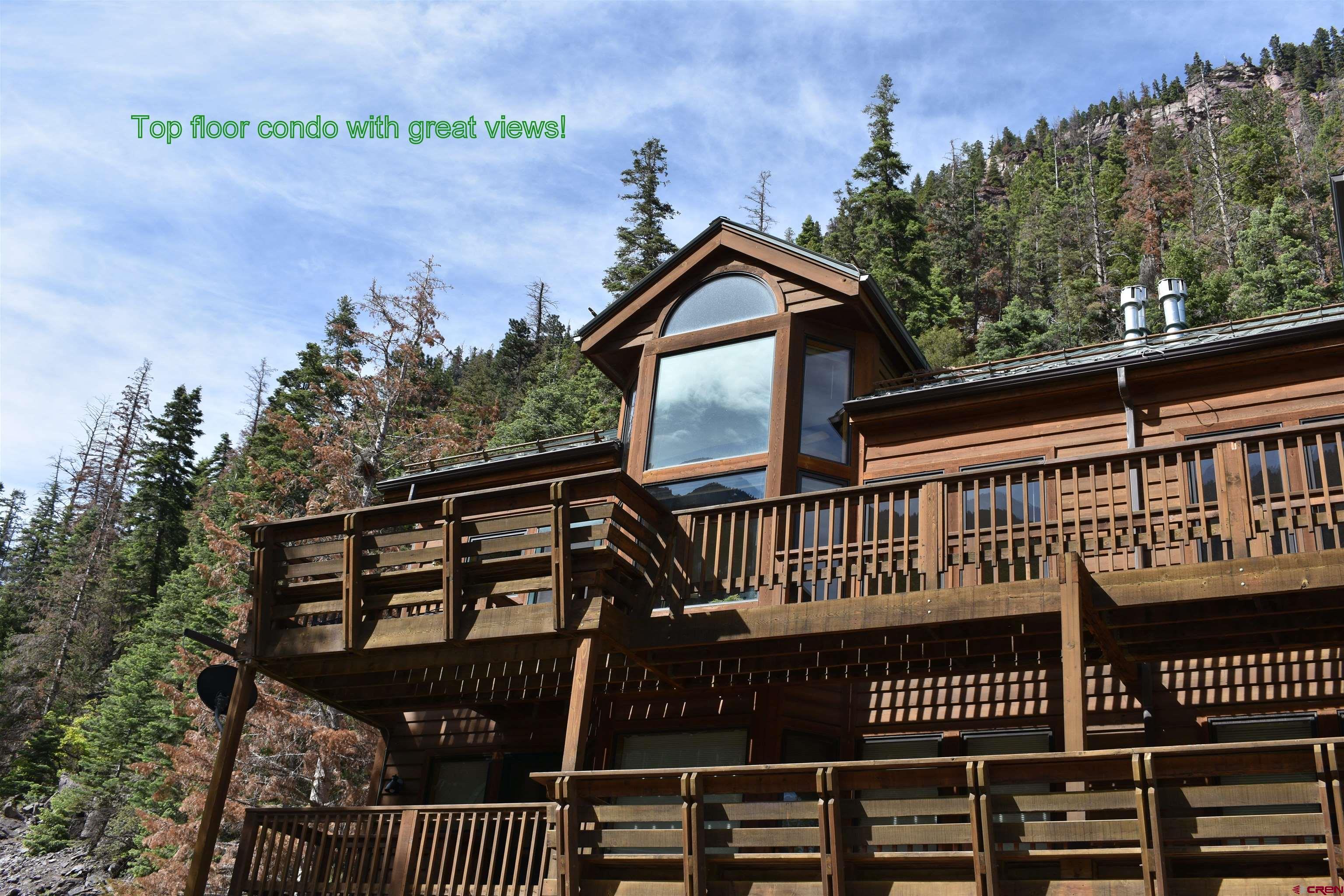 This furnished penthouse end unit in the Grand View Condominiums has two story windows framing the beautiful Bridal Veil Falls and all of Gold Hill.  There are two formal bedrooms and one loft bedroom which can double as an office or play room.  The living room has a gas log fireplace and beautiful windows creating a light and bright environment.  The kitchen and dining room have south facing windows with views.  The back deck has an awning to shad the hot summer sun from your outdoor space.  There is a nice table and chairs set and a BBQ grill.  The kitchen is charming with new appliances and sturdy oak cabinets.  There are nice sized closets in the bedrooms, entrance way and loft. The over-sized one car garage comes with a workbench, shelves and storage bins.  This place is ready to go, and zoned for short term rentals.  There are still short term rental licenses available in the City of Ouray.  Come check out this gem, won't last long.