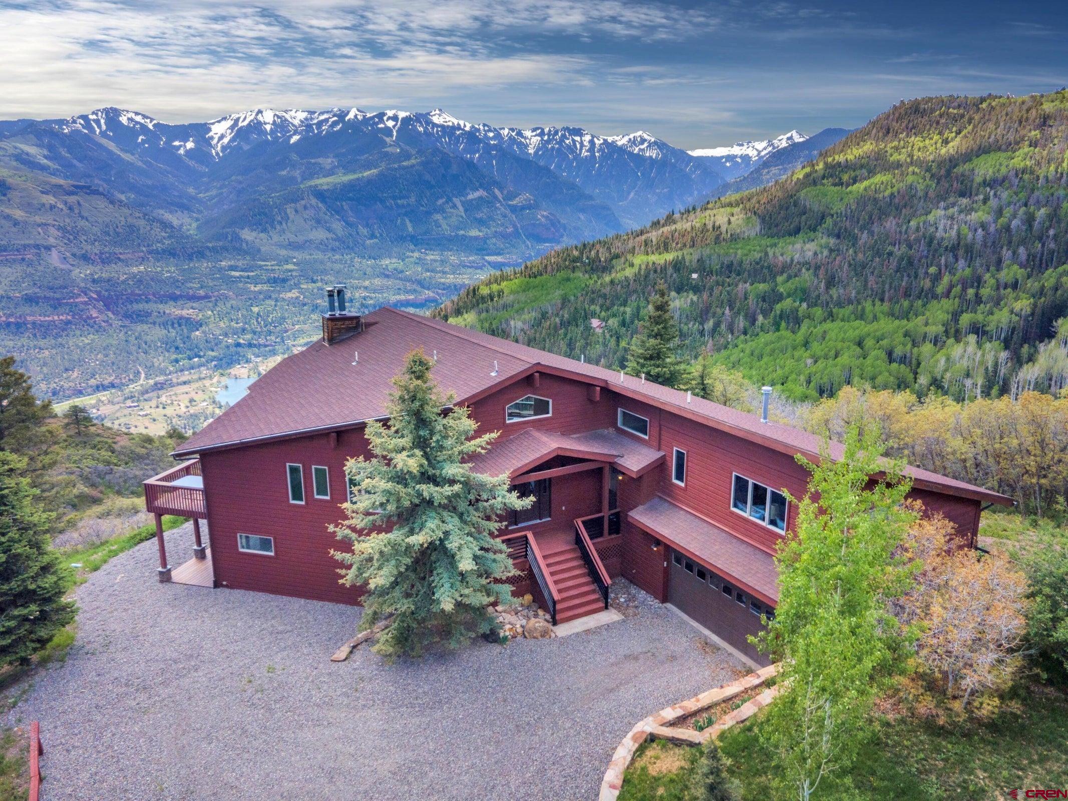 Views like you've never seen before! This 4-bedroom (plus flex) home is perched at the top of Elk Ridge Trail, highlighting the stunning 180-degree vistas that span from Grand Mesa to Mt. Abrams to Mount Sneffels. The upper-level living spaces are framed with a panoramic Trex deck, while the lower-level bedrooms have walk-outs to a lower deck and a newly installed patio. This meticulously-maintained home includes two 2-car garages and is situated on 35 acres in a gated community with year-round access, close proximity to recreation on Forest Service land, and a short drive to Ouray & Ridgway. Conveniently located near every outdoor activity imaginable, two hot spring resorts, & the Telluride & Silverton Ski Resorts, 1600 Elk Ridge trail is the ultimate Colorado mountain retreat.