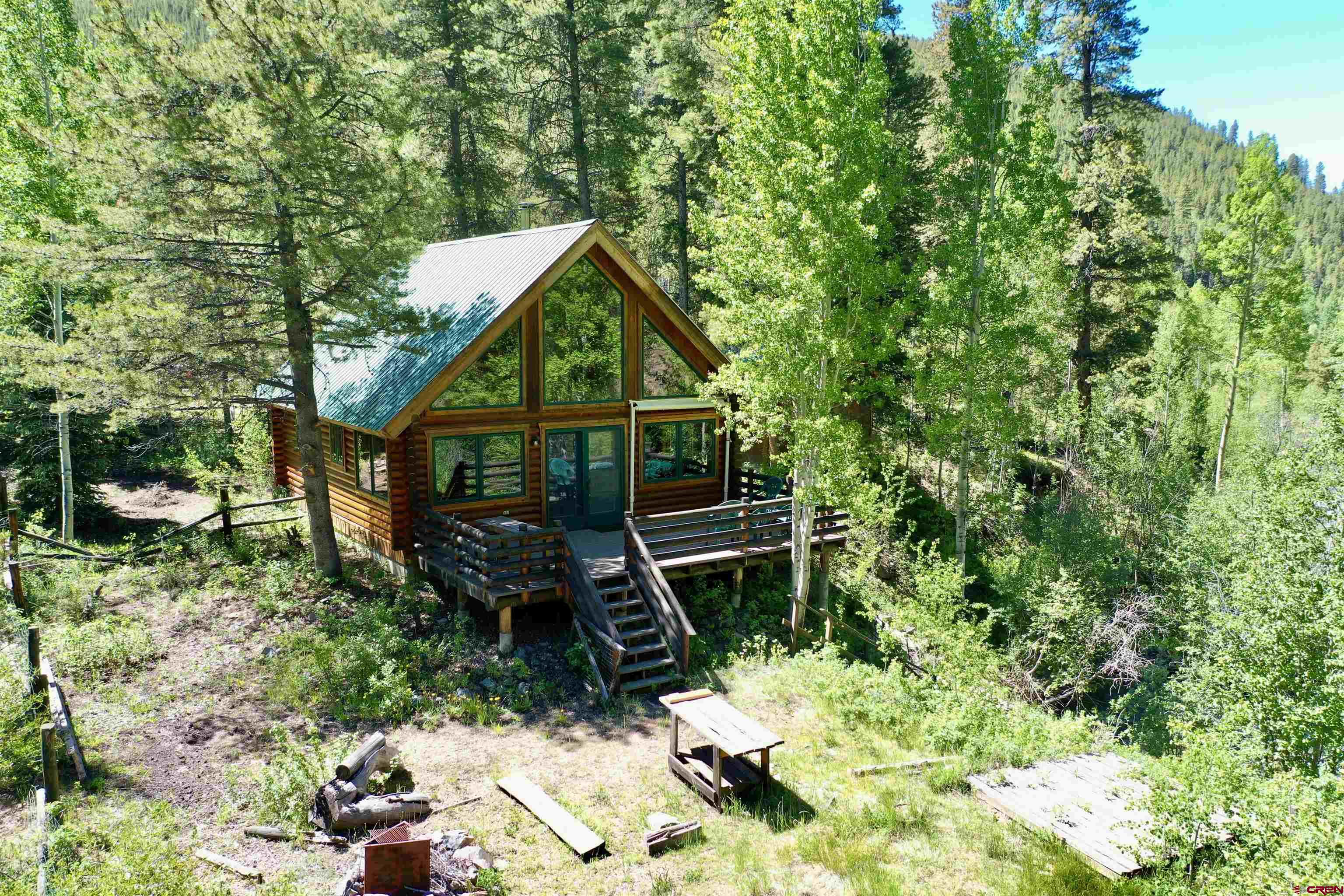 Welcome Home to your 1 bedroom/1 bath mountain home with loft nestled in the trees with Gold Creek in the backyard and on 3+/- acres. 3.5 miles from Ohio City and 45 minutes from downtown Gunnison and 30 minutes from the Pitkin area. Property is bordered by national forest. Built in 1994, with well & septic, generator & shed and approximately 1,008 square feet. Off-grid cabin in the Colorado mountains is close to hiking and 4-wheeling trails. This property has other locations to park additional RV's and camp trailers to make this the family summer cabin! Schedule your showing soon and enjoy the rest of summer on the back deck!