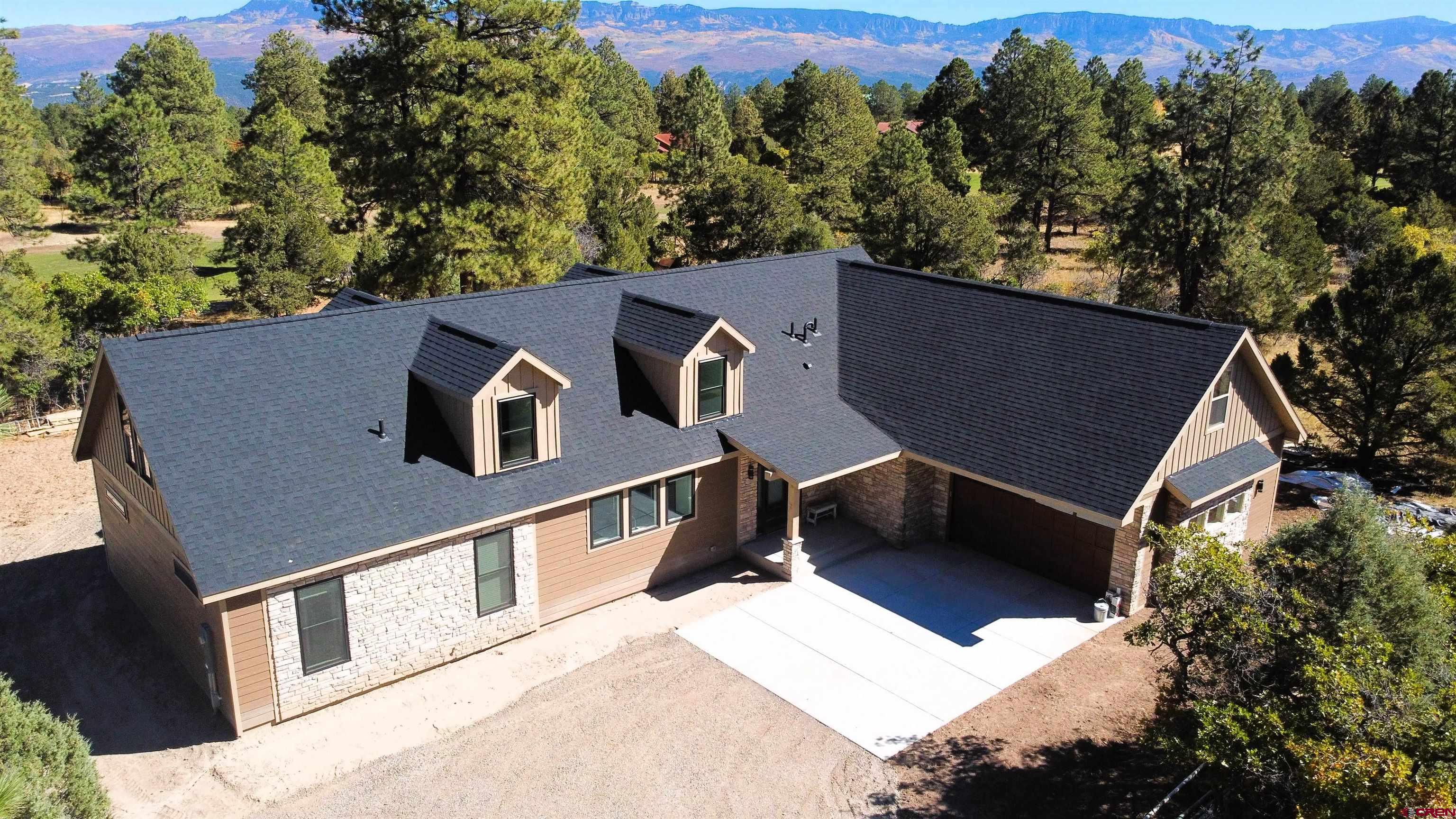 Welcome to golf front living that is less than 1 hour away from world class Telluride skiing. This brand new 1 acre property has everything you’ve been looking for. This isn’t the same dated rustic design you’ve been seeing over and over again. This is the custom craftsman contemporary home that you have been dreaming of. As you walk through the main entry way to the home, the first thing that will grab you is the natural light; This is due to the custom 10’ sliding glass doors that showcase your one of a kind forested views. Your mind will immediately start racing with all of the potential for entertaining that comes from having such a cohesive indoor to outdoor living space. Imagine hosting the 4th of July, where your guests can watch golfers chip onto the green in your back-yard while enjoying appetizers in your kitchen.  Speaking of the kitchen, you’ll never want to cook anywhere else ever again. This chef’s kitchen boasts a 55 cubic foot commercial-scale stainless fridge, 40sqft island, quartz countertops, 2 independent wall mount ovens, oversized pantry, and more. The space was made to truly embody the word “gourmet.”   Head into the master bedroom and you will find your home’s excellent views continue, without compromising on privacy. The master bathroom could more accurately be described as a spa. The space is fitted with a custom tile shower, double vanity, and a freestanding soaker tub. When you head to the guest bathroom you will see that no expense was spared. The space is also complete with a custom tile shower as well as ship lap accenting over your guest sink. But, the main floor is just the start.  As you head upstairs you will find that this custom home just keeps on giving, with a large game room, 2 additional bedrooms, another full bathroom and a hidden bonus room. Upstairs walls have been independently insulated dampening the noise between the floors. Looking out the windows you will find the views only get better while bringing in the natural light throughout the day. In the surrounding area there are more activities and attractions than there’s room to list here. Residents can snowshoe and cross-country ski on the golf course all winter long, make the trek to the famous RAT trails for mountain biking just 15 minutes away, or go fly fishing on the gold medal Pa-Co-Chu-Puk waters below the Ridgway reservoir.   Make sure to schedule your private showing for this home right away because it will not last!