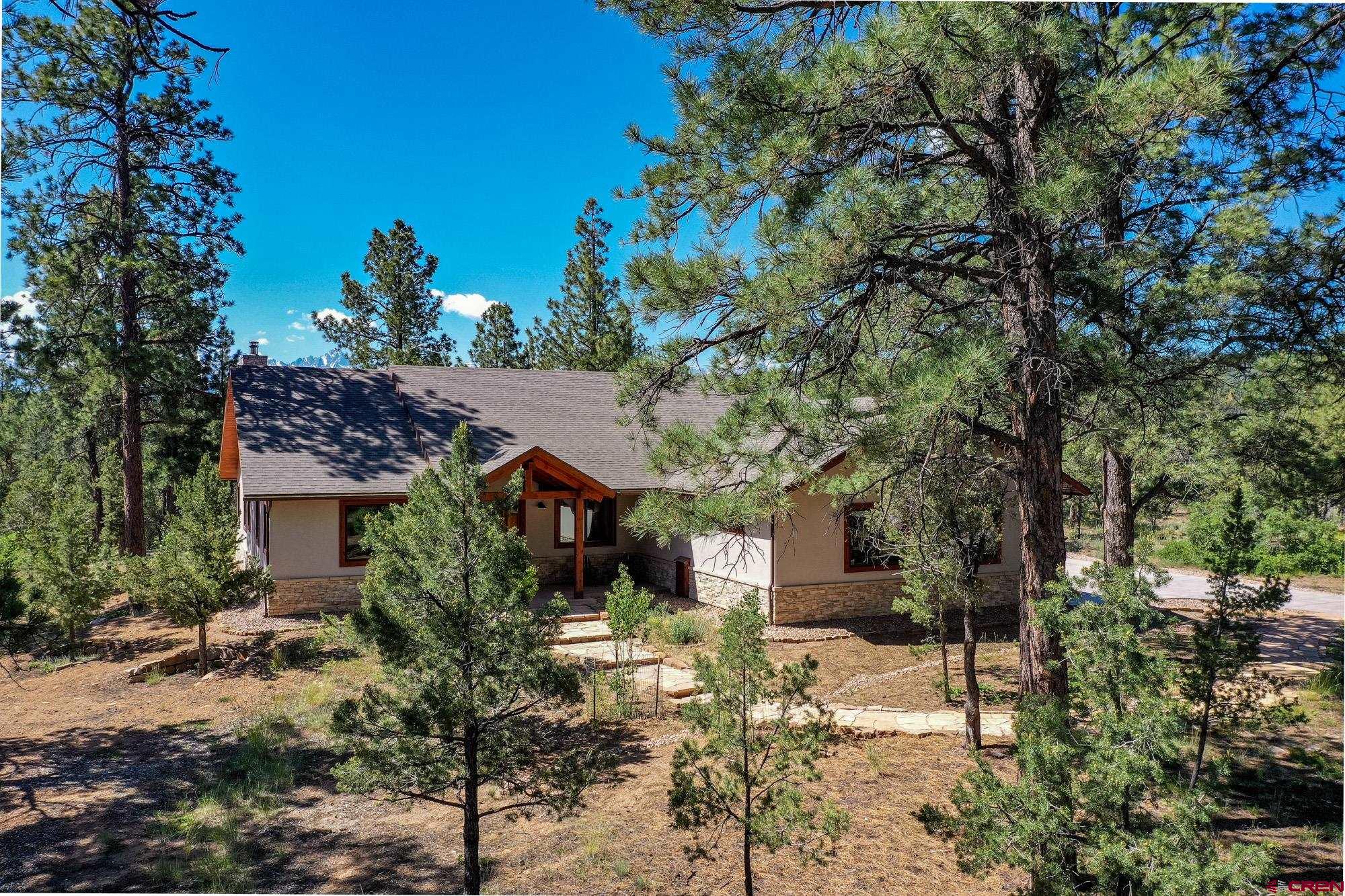 Surrounded by mature pines with stunning views of the Sneffels Mountain Range, arrive to your thoughtfully designed all one-level living home with an open floor plan beautifully appointed with the finest finishes and amenities including white Oak wood floors, Miele kitchen appliances and Kohler plumbing fixtures. Two generous en suite bedrooms and a 'flex' room that comfortably offers you a third bedroom are joined by a spacious open living, dining and kitchen area highlighted by views of the 4.28 acre outdoor landscape and picturesque rocky mountain peaks. The convenience of this finely cultivated home is highly desirable: minutes to the Divide Golf Club; 15 minutes to the town of Ridgway; 20 minutes to Montrose and Ouray; and 45 minutes to the world-class Telluride resort.