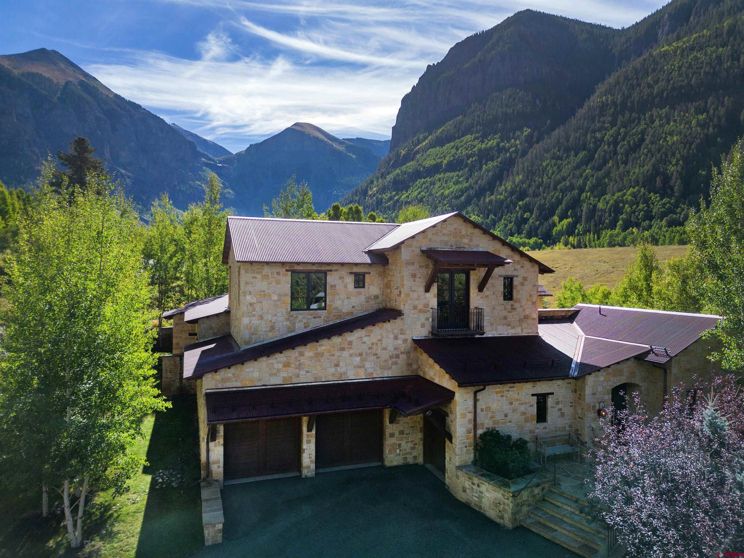 This stunning estate is located in the highly desirable Idarado Legacy neighborhood. It is perhaps the most beautiful of all mountain settings, just a short walk from downtown Telluride. The home's exquisite Spanish Colonial Revival architecture was developed by award winning Ryan Street Architects. The elegant hacienda's interior was designed by Rachel Mast Design and built by Telluride's deLuca Construction with the most meticulous attention to detail. The six private bedrooms, large common areas, decks and patios were thoughtfully created to accommodate festive gatherings, while showcasing sweeping views of Telluride's majestic mountains. With over 8,700 square feet, this beautiful home is available to host almost any occasion.