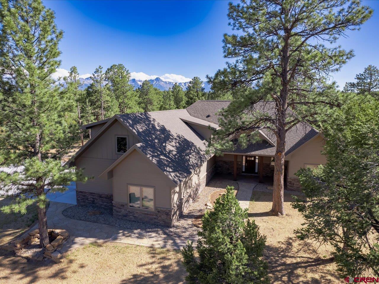 Welcome to your dream mountain retreat located just outside the picturesque Western Colorado town of Ridgway, positioned on the 10th hole of the prestigious Divide Ranch & Club golf course! This extraordinary property finished in 2022 was meticulously crafted by Design Build Unlimited, renowned for their exceptional craftsmanship and attention to detail. As a result, you'll benefit from a home lightly lived in, maintaining its pristine condition for its lucky new owners. The property is a true turn key offering as it comes with all carefully selected furniture* and rugs*, a 75” television in the living room and 55” televisions in each bedroom, all kitchen amenities, an outdoor grill, bedroom and bathroom linens, all lamps and wall hangings*, outdoor activity equipment including 2 E bikes, 2 sets of golf clubs, 2 sets of snowshoes and poles, ½ court pickleball net with rackets and balls…all its waiting for is you! (*some personal items are excluded). Beautifully nestled amidst the tranquil ponderosa pines, your home offers a sense of seclusion and serenity. Inside you'll be captivated by the blend of contemporary elegance mixed with just a touch of mountain charm - the exquisite finishes, the inviting atmosphere, the views of the golf course and mountains beyond and the surrounding nature - mountain living at its finest. The open concept great room provides perfect ambiance whether casually entertaining guests from the large kitchen island, hosting a more formal dinner, grilling and entertaining outdoors, or enjoying a quiet, cozy evening in front of the stone gas fireplace while watching the snow fall or the sunset hit the peaks of the mountains in the distance. This home is perfect for year-round living or for both summer and winter retreats from everyday life elsewhere. With 4 bedrooms and 4.5 baths, there’s plenty of room for family and/or guests. The split floor plan offers privacy to the main level master bedroom with its large ensuite with heated floors and boasting a separate shower, a spacious soaker tub, and large master closet. (The master bedroom can also be locked off to the remainder of the home.) Two additional main level bedrooms each come with their own private bathrooms featuring elegantly tiled showers, one with a tub/shower combination, providing additional privacy and convenience for all. Upstairs, you’ll find another full bath and an additional large bedroom or family room with a picture window featuring stunning views of Courthouse Peak! The gourmet kitchen is a chef’s delight, well-appointed with all appliances including a wine refrigerator, and spacious butler’s pantry. Stained alder wood craftsman-style cabinets throughout the home with stylish hardware. Beautiful white oak hardwood flooring spans the kitchen, dining, living area and master bedroom of the home, with carpeted bedrooms and tiled baths. Ceiling fans are in all bedrooms and the living room.  Large laundry room with cabinetry and utility sink and included washer and dryer. Bench area just off the garage for coats and boots. Oversized 2-car garage with additional driveway for 3 cars. Hunter-Douglas blinds throughout. Forced air-natural gas heat and central air conditioning on 2 separate zones with a whole house humidifier add to the comfort of the home. Professionally landscaped with a fully fenced backyard. Stay connected with the world thanks to Clearnetworx fiber internet. Travel easily to anywhere via the Montrose Regional Airport just 40 min north, soak in the famous Ouray Hot Springs 30 min down valley, paddleboard at the Ridgway Reservoir, fish the gold medal waters of Gunnison River, jeep, hike or bike in every direction,and enjoy world class skiing in Telluride in about an hour. This property is not only a home; it's a lifestyle. You’ll find yourself surrounded by natural beauty and recreational opportunities that will enrich your life in every way.