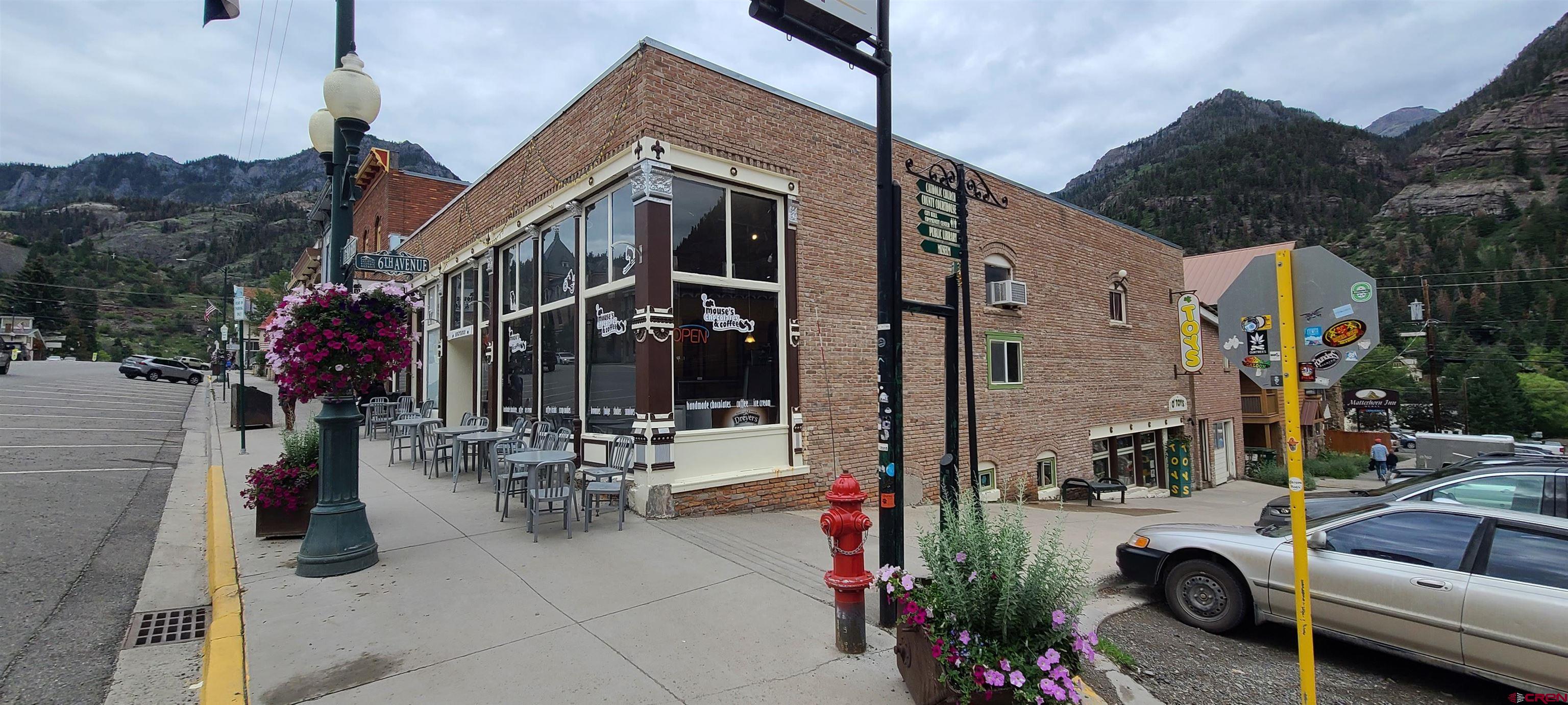 Own a premier building in Ouray Colorado. Incredible opportunity for a creative entrepreneur. Building has one residential unit and one commercial rental on 6th Avenue and the retail and production areas of the beloved Mouse's Chocolates. The lower level can be adapted to a variety of different residential or commercial uses. Mouse's Chocolates is Renowned for great house roasted coffee, Belgian truffles, and tasty Ice Cream treats. This is the premier corner in Ouray An additional floor could be built on the existing structure under the Ouray code and height limit of 35 feet.  The business of Mouse''s Chocolates is for sale under a separate listing.
