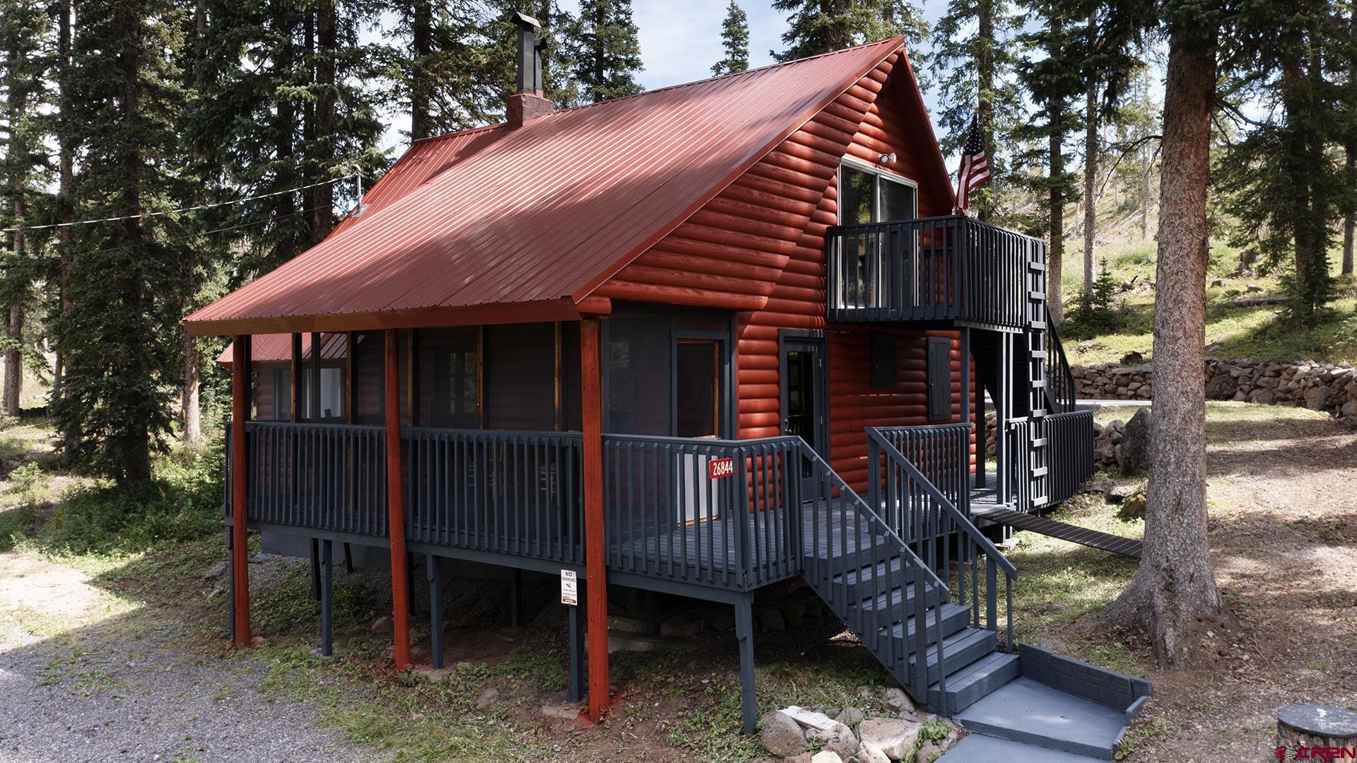 Solid Cabin with several amenities located on the Grand Mesa. Great location backing up to National Forest on a quiet circle drive away from the main roads. There are two different water sources consisting of domestic resort water and a well which is what the Sellers currently use. This property has a permitted septic system eliminating the task of seasonal pump outs from the typical vault system. Two propane tanks to last through the winter. In addition to the propane forced air furnace there is a nice wood stove that has no problem heating the entire cabin. Both levels have at least a 3/4 bath each with a shower. Beautiful Hardwood floors really make the interior pop! Modern kitchen set up with good cabinets and appliances! Attached wood storage shed so you do not have to go outside in the winter to retrieve wood. Big deck with a large screened-in porch for bug free enjoyment! The deck and cabin were recently painted. Expanded crawl space makes for good extra storage. There is a 14x24 slab with J bolts ready to build a garage on! This place is set up for year round use! This cabin is part of the Grand Mesa Resort Company with dues of $520/year. Buyer will receive a share of stock in the Grand Mesa Resort Company. No real estate being conveyed. No winter road maintenance. Cabin being sold "as is" and furnished.