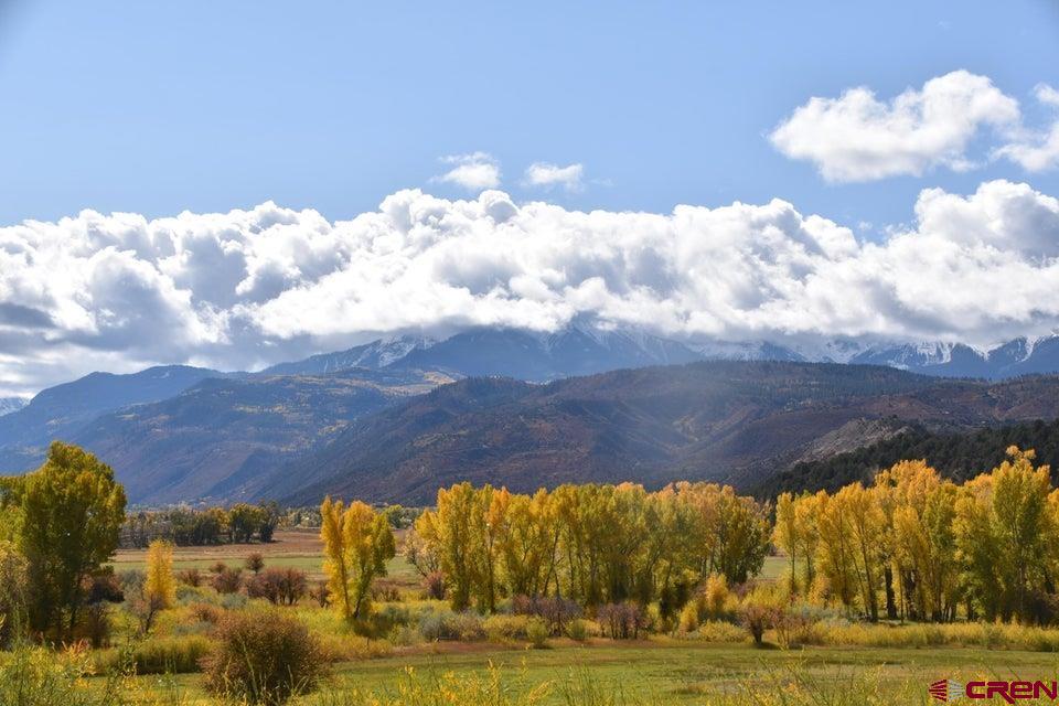This lot provides striking, unobstructed views of the San Juan Range, including Mt. Sneffles, the Cimmarron Range, and the Ouray Valley of Mt. Abrams.  The lot has  a Tri-County Water Tap, a natural gas connection at the lot line, power to the lot line, and a fire hydrant at the lot corner. You will have ample space to construct your ideal home with a walk-out basement and accommodate all of your toys, animals and more!  This property is conveniently located near Ridgway State Park, downtown Ridgway, Ouray, Telluride, and major shopping in Montrose. Few properties in the area offer such breathtaking views, and the absence of covenants allows you to build your dream in Ridgway.
