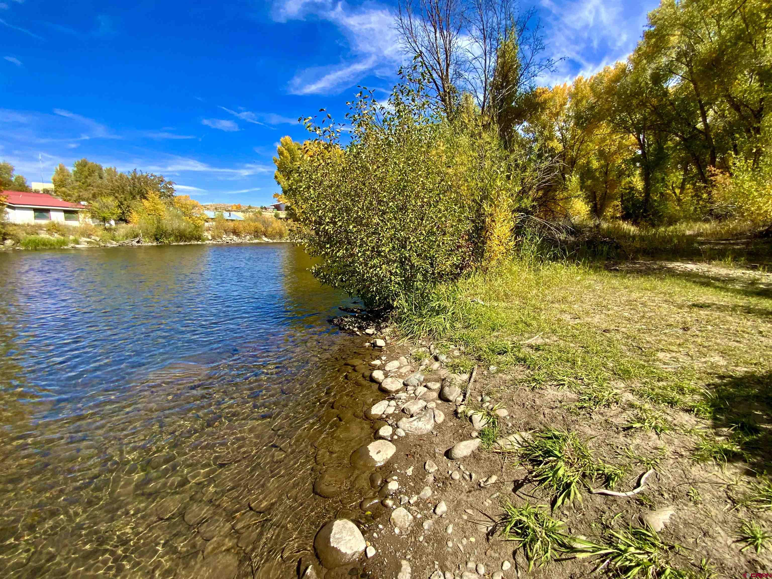 Waterfront building site to build your new home!  Great opportunity to own on the Gunnison River, hidden between the trees & close to the White Water Park. Two lots totaling 1.798 acres available. Enter through Dos Rios 1 between the 1st & 2nd houses on the right. Property is not in the Dos Rios subdivision, but there is an agreement to abide by Dos Rios 1 architectural control. No dues or fees. There is deeded access in place to cross HOA lands off of Rio Vista.  Only  a few river lots remain in the Gunnison Valley.  Level building site with mature trees and still close to downtown conveniences.