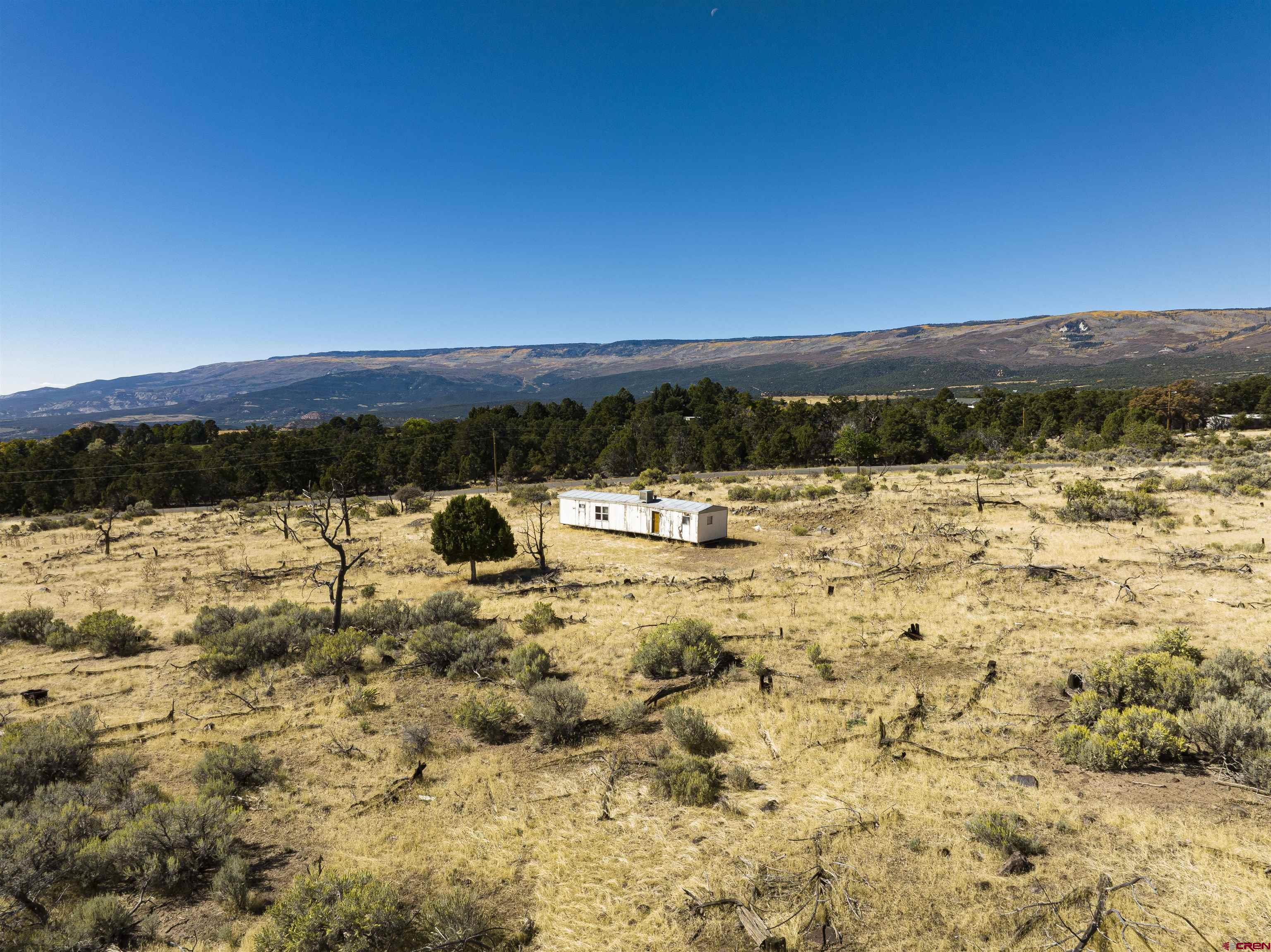 Come check out this 5 acre build site up surface creek rd. Views of the Grand Mesa as well as expansive views of the San Juans. You can even see the Fruit Growers Reservoir from this property. There is a leveled pad that has a mobile home sitting on it. Mobile is a 1986 Park Ridge / Champion 14x56 Serial # 4268385984. There is no water tap and nothing hooked to the mobile. Buyer to research about water tap availability and cost. Property and mobile are sold as is.