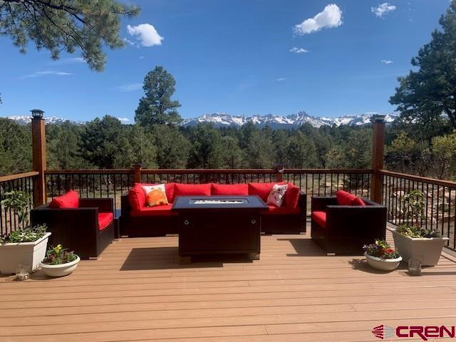 Stunning Sneffel mountain views from every room!  This beautiful custom home was built to capitalize on the views and bring the beauty of CO indoors. The great room, dining and kitchen open floor plan leads to the large deck, hot tub, gas fire table through 16 FT sliding glass doors...an entertainer's delight. Fully-furnished; Short term rental permit optional transfer to new owner.   Custom cabinets, granite countertops, built in bar with wine refrigerator and counter seating at a custom "live-edge" juniper with copper inlay are just a few of the kitchen features. Enjoy the luxury of a spacious master bedroom complete with a stone fireplace, sliding door to deck and hot tub, barn doors with art nook, large windows and closet.  The master bath has separate vanities, clawfoot tub, walk-in shower and stone floor. Your guests will enjoy the privacy of the split plan second master with an ensuite bathroom; private entrance and deck. The circular staircase leads to the loft and can accommodate additional guests, an office or game room. A large bright studio/office above the garage offers a separate space to work or create.  The garage is 3 car size and insulated; landscape includes native aspens, ponderosa pines and gardens/water feature flowers are deer resistant.  Other custom elements include: Pella windows, exterior real native stone (excavated from this lot) slate and stone floors, stone fireplace and rusted metal fireplace, solid alder doors. Walk to the clubhouse and play unlimited golf (pay for cart only) in the summer; hiking, mountain climbing, ice climbing, boating, fishing, skiing, biking. Located just 6 miles from the historic town of Ridgway, from Montrose Regional Airport; 45 minutes from Telluride's world class skiing and 10 miles from Ouray's famous hot springs and the San Juan Skyway.30 minutes to Montrose Regional Airport and 5 miles from downtown Ridgway and 14 miles to Ouray.   Virtual tour represents video of Divide Ranch and Club and sample of owner/builders other projects. Seller is a licensed agent in CO and AZ