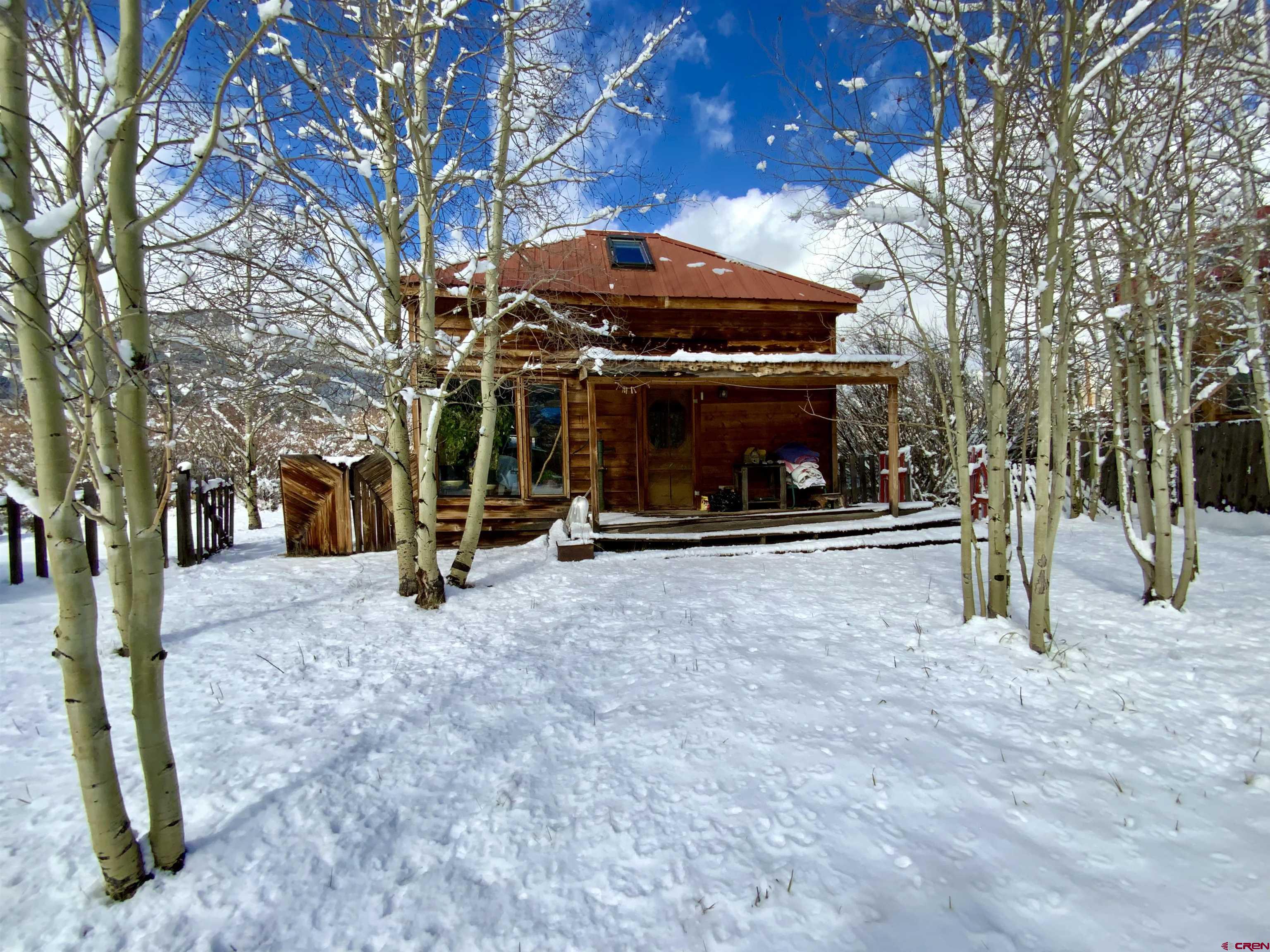 Comfortable and cozy cabin at a quiet and peaceful end of the road location in the town of Pitkin, just 45 minutes from Gunnison.  One bedroom/1 bath home sits on 4 lots and offers willows for privacy and an aspen forest out front with a miscellaneous outbuilding that would make a great workshop or could be updated for a guest house.  Open kitchen and dining room feature a Range/Oven, Microwave, Refrigerator and the house is heated with a woodstove and electric baseboard.  Plenty of passive solar through the windows with occasional moose, deer and elk visits.  Two woodsheds out front, well, shared septic and metal roof.  The washer and dryer are in the spacious bathroom and there’s an office nook off the living room with coat closet and under the stair storage.  Currently used as a year-round home but would make a great summer cabin or hunting cabin!