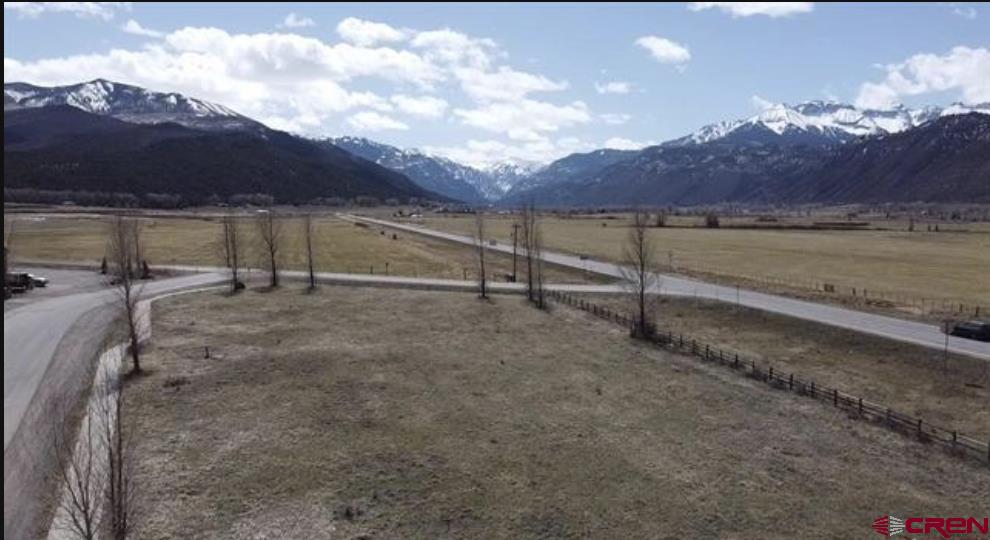 Over 1 flat acre of highly visible COMMERCIAL lots in Ridgway with HIGHWAY 550 FRONTAGE. Possible mixed residential use (check with town of Ridgway to confirm requirements). Exceptional views and southern exposure from this special property. This is a great investment with multiple opportunities on this rare commercially zoned land with unparalleled exposure in Ridgway. Accessible via County Road 12 (off Hwy 550) or Hunter Parkway (Zoned:General Commercial). Total taxes listed are for both lots 12 L& 13 combined