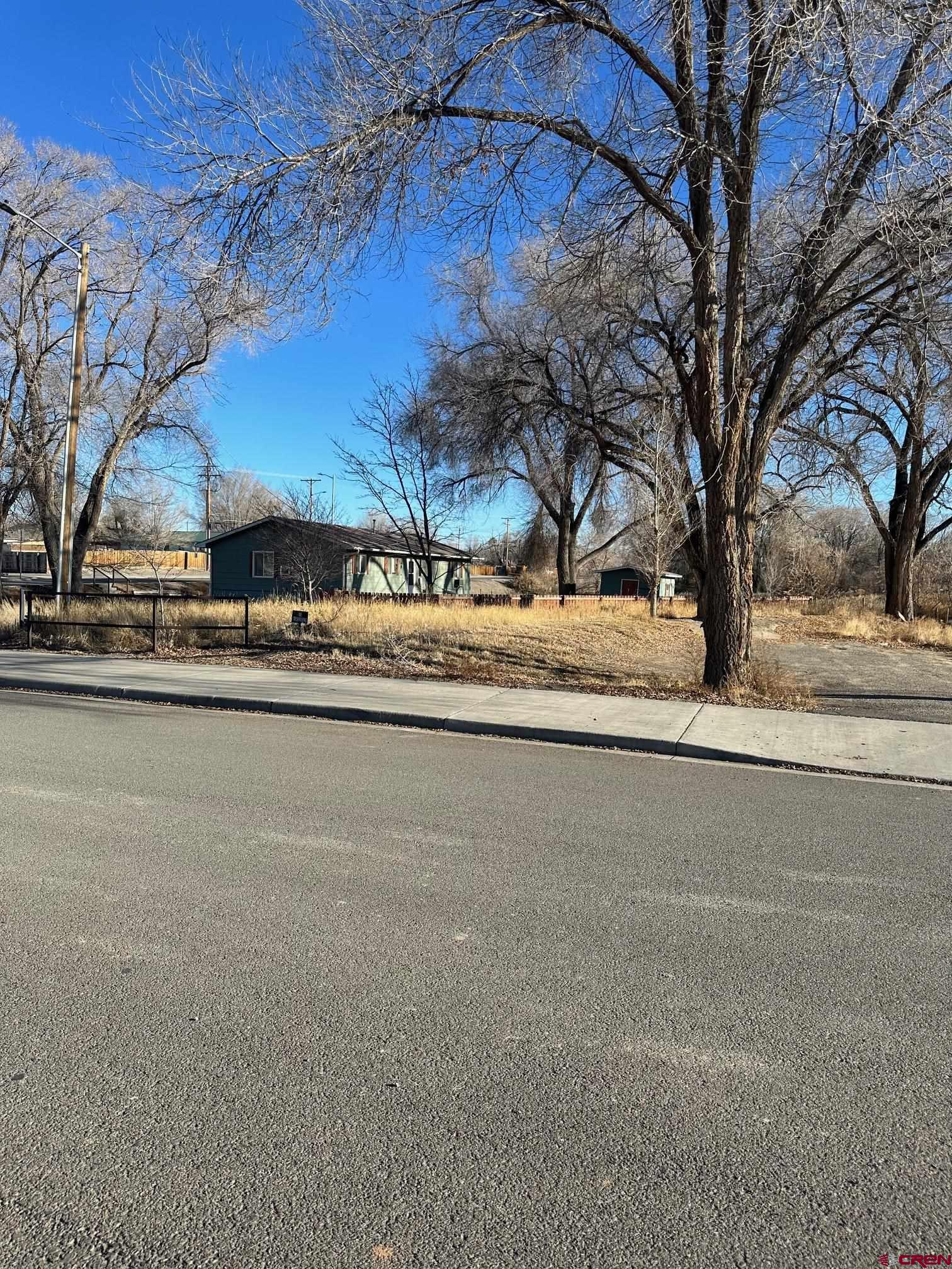 Rare commercial lot adjacent to the Uncompahgre River and bike trail. This lot is offered at a recently appraised land price as if it did not have a home on it. The home is 3/2 rental and has a current tenant with a month to month lease.