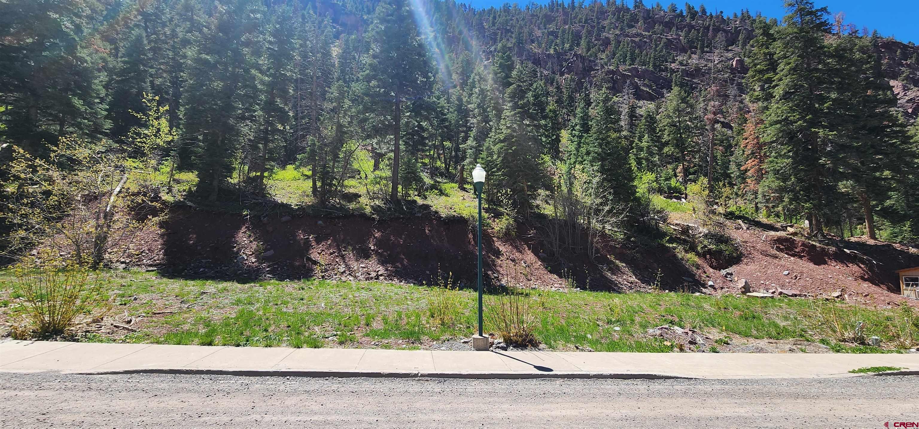 Ready to build lot in the resort City of Ouray. All utilities at the lot line. Property backs to National Forest with easy access to the Silver Shield trail. Unique views of old mining structures on the mountain side. Walk to town on the North Ouray Corridor trail loop along the Uncompahgre River. Zoning allows single family, multi-family, guest residence and other uses.